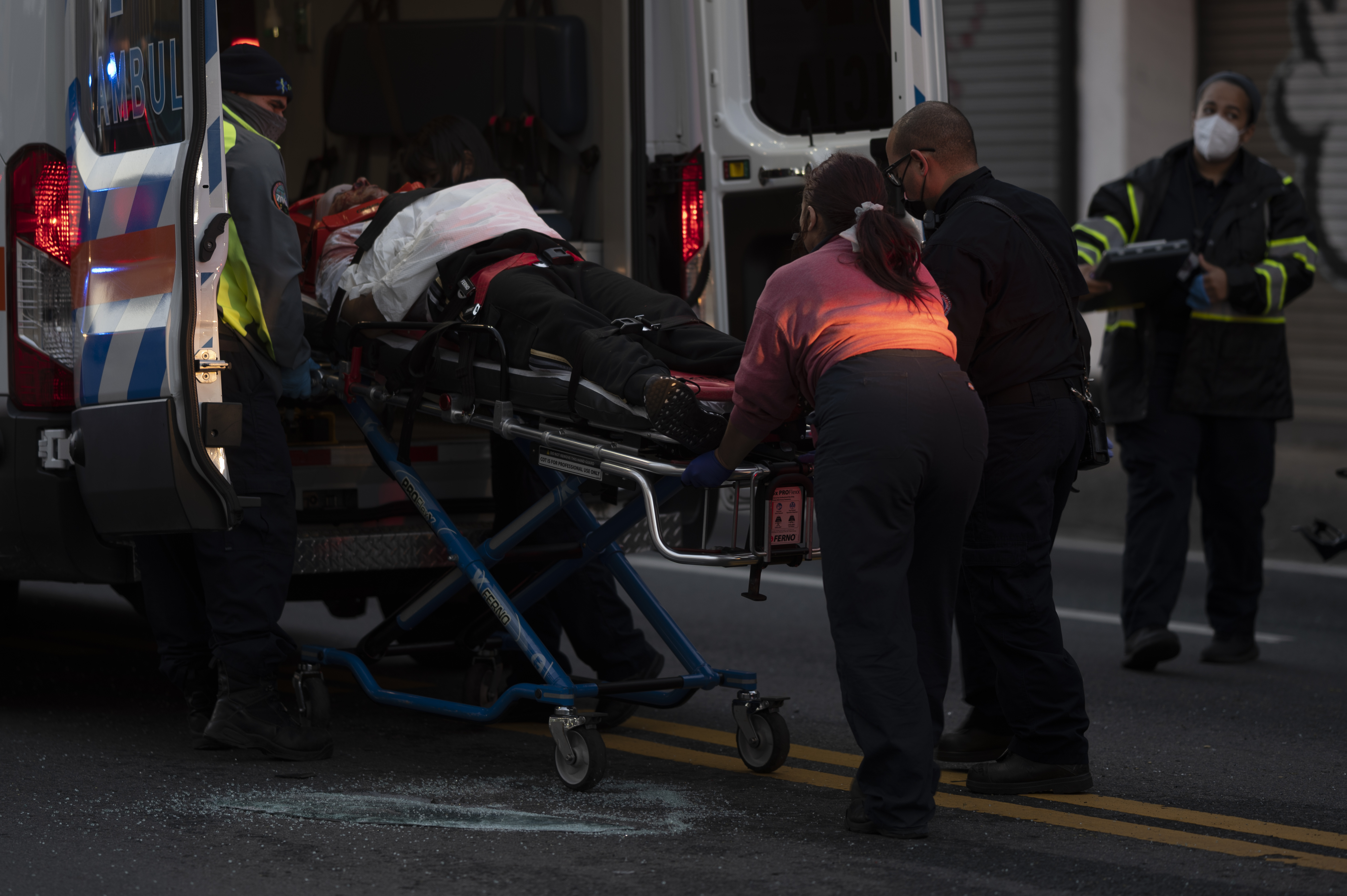 First responders give medical assistance to a driver on R.H. Tood Avenue after a car crash near an intersection during a blackout in San Juan, Puerto Rico