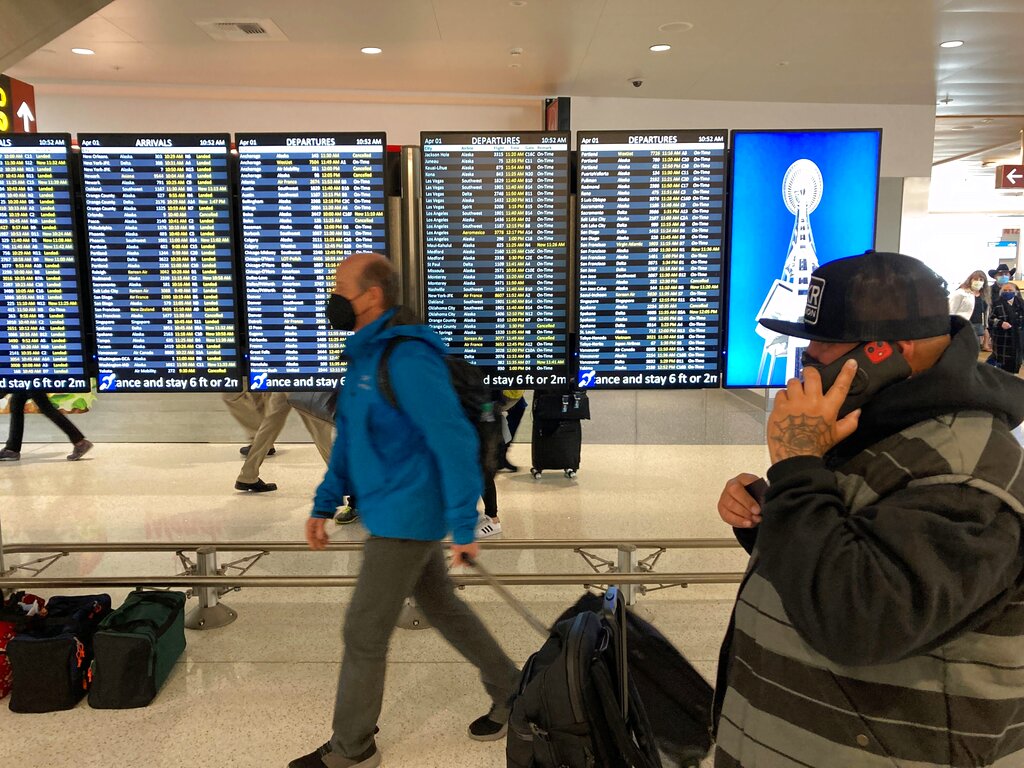 Travelers walk through Seattle-Tacoma International Airport.