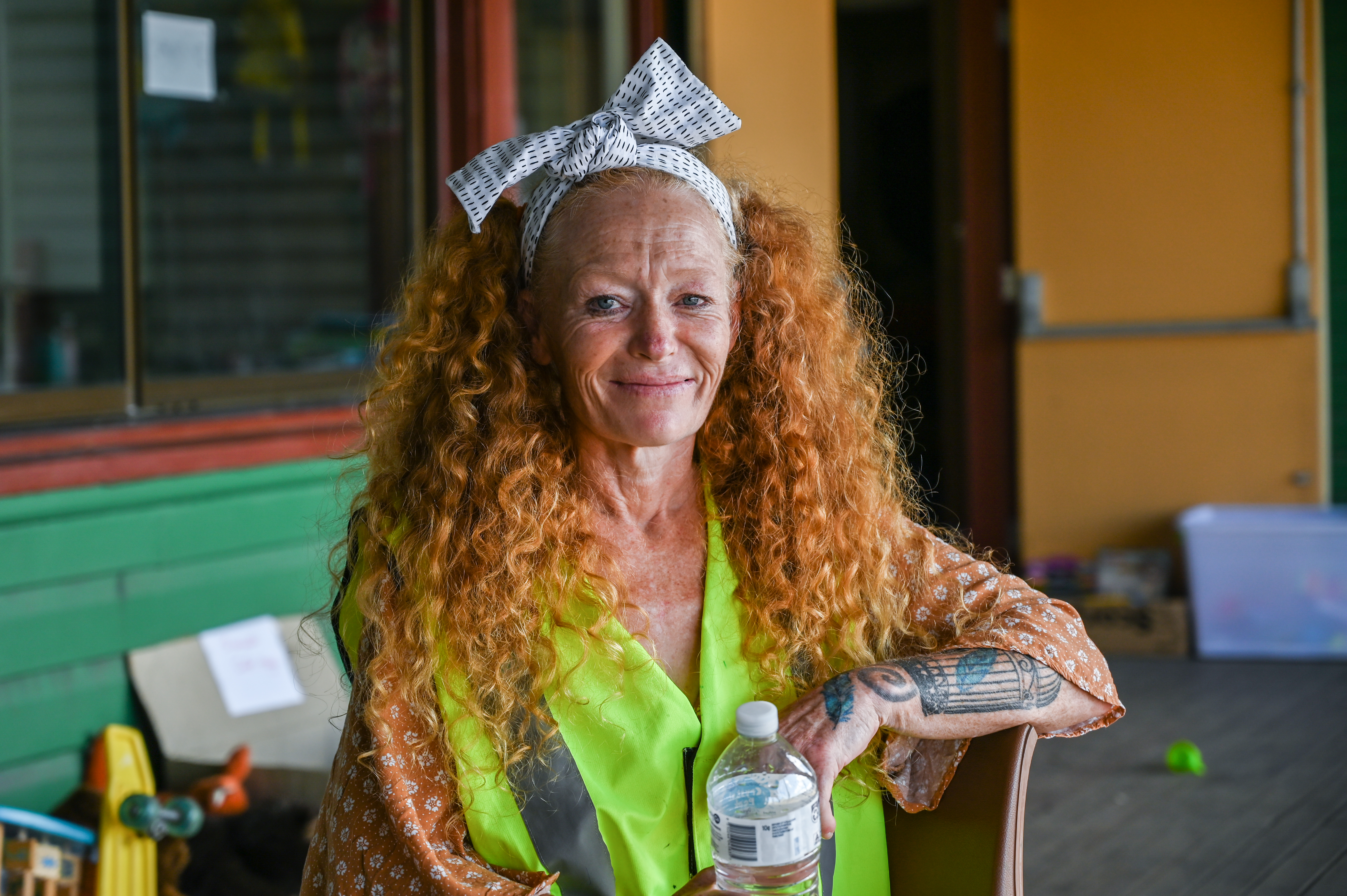 Woodburn resident MJ in a lime green shirt, her curly ginger hair tied in a bow