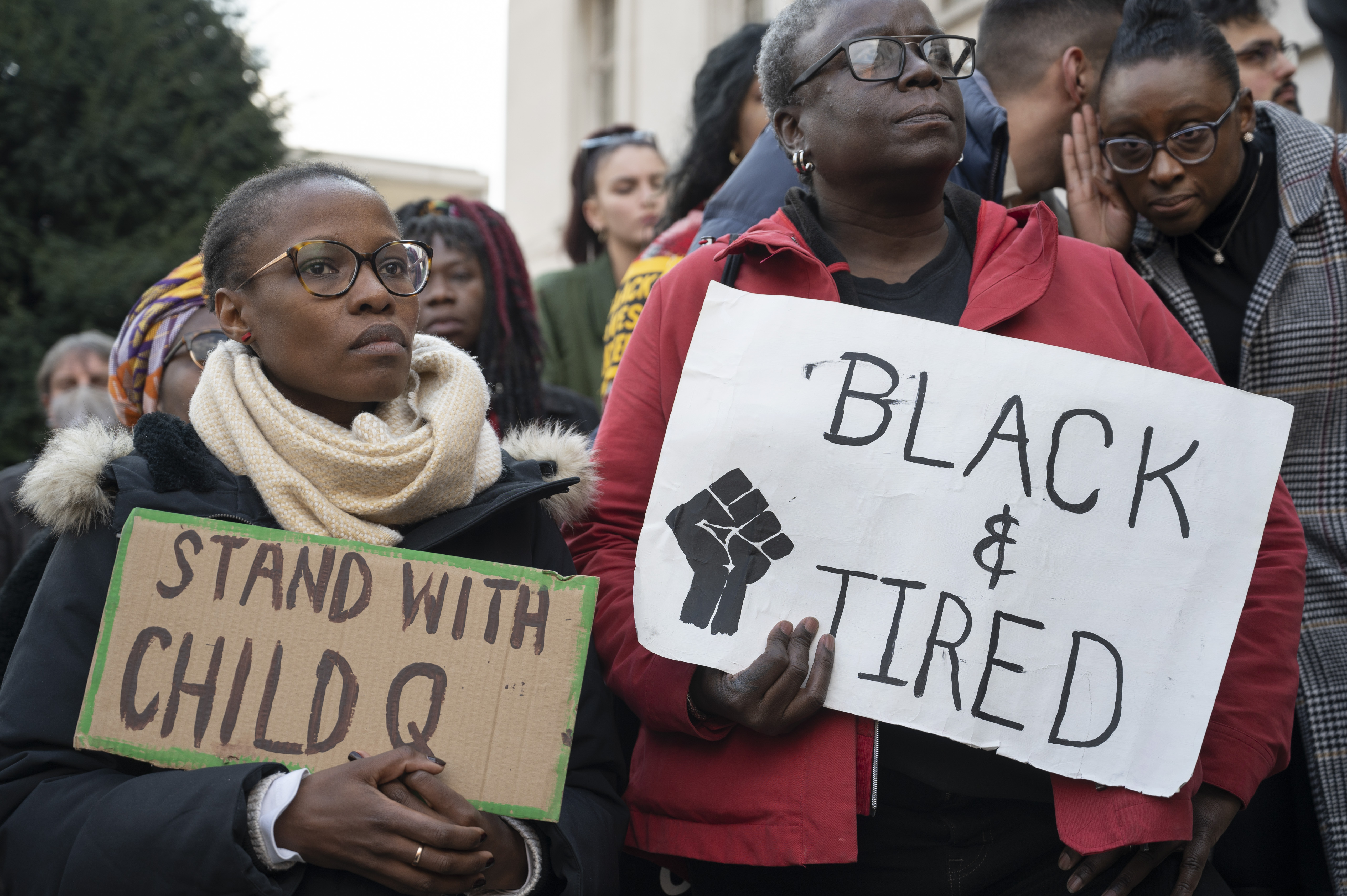 Protesters seen in front of Hackney Town Hall holding placards that read "stand with child Q" and "Black and tired"