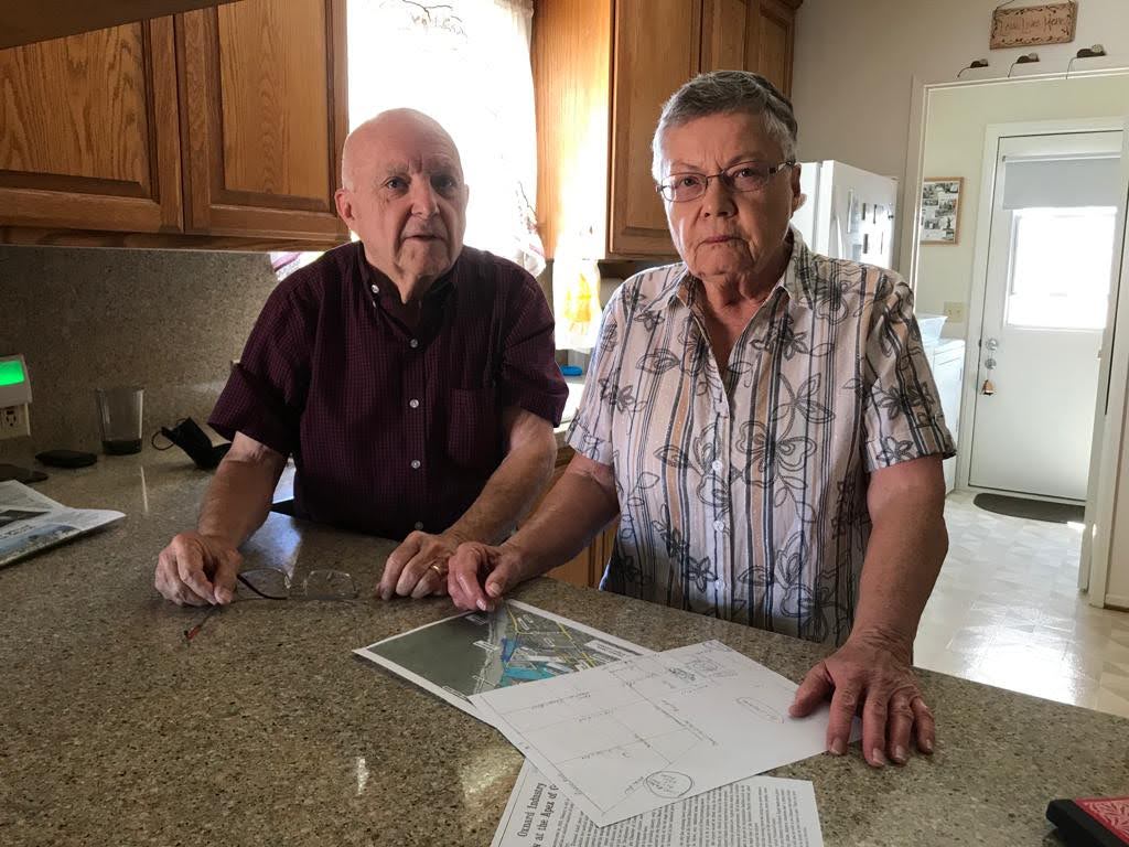 Larry and Shirley Godwin place a hand-drawn map of the area surrounding their neighbourhood, including a slag heap abandoned years ago by the company that operated it.