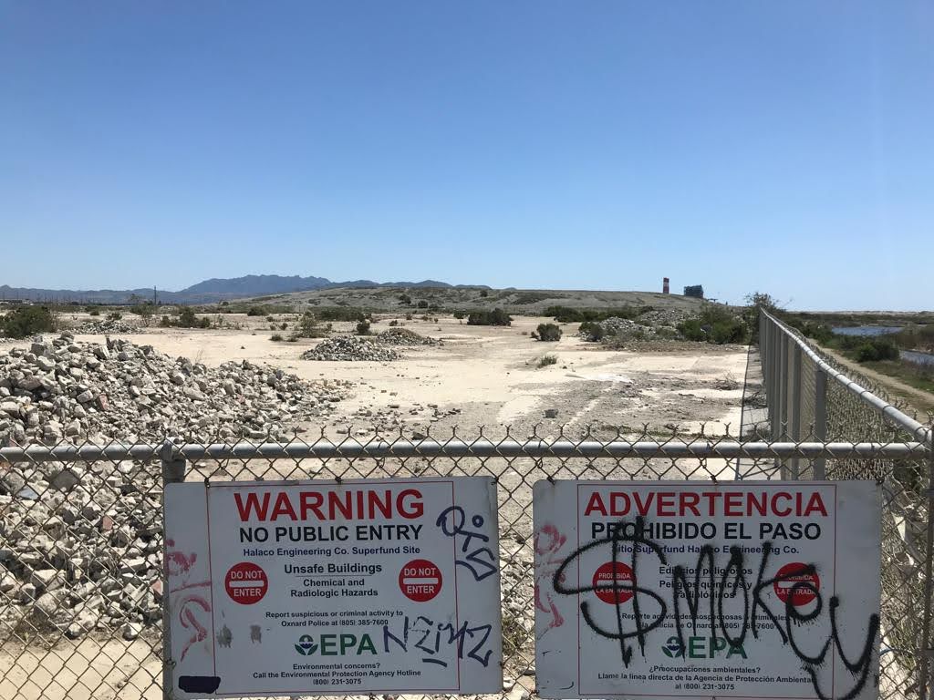 Signs warn of no entry allowed to a US federal Superfund environmental clean-up site.