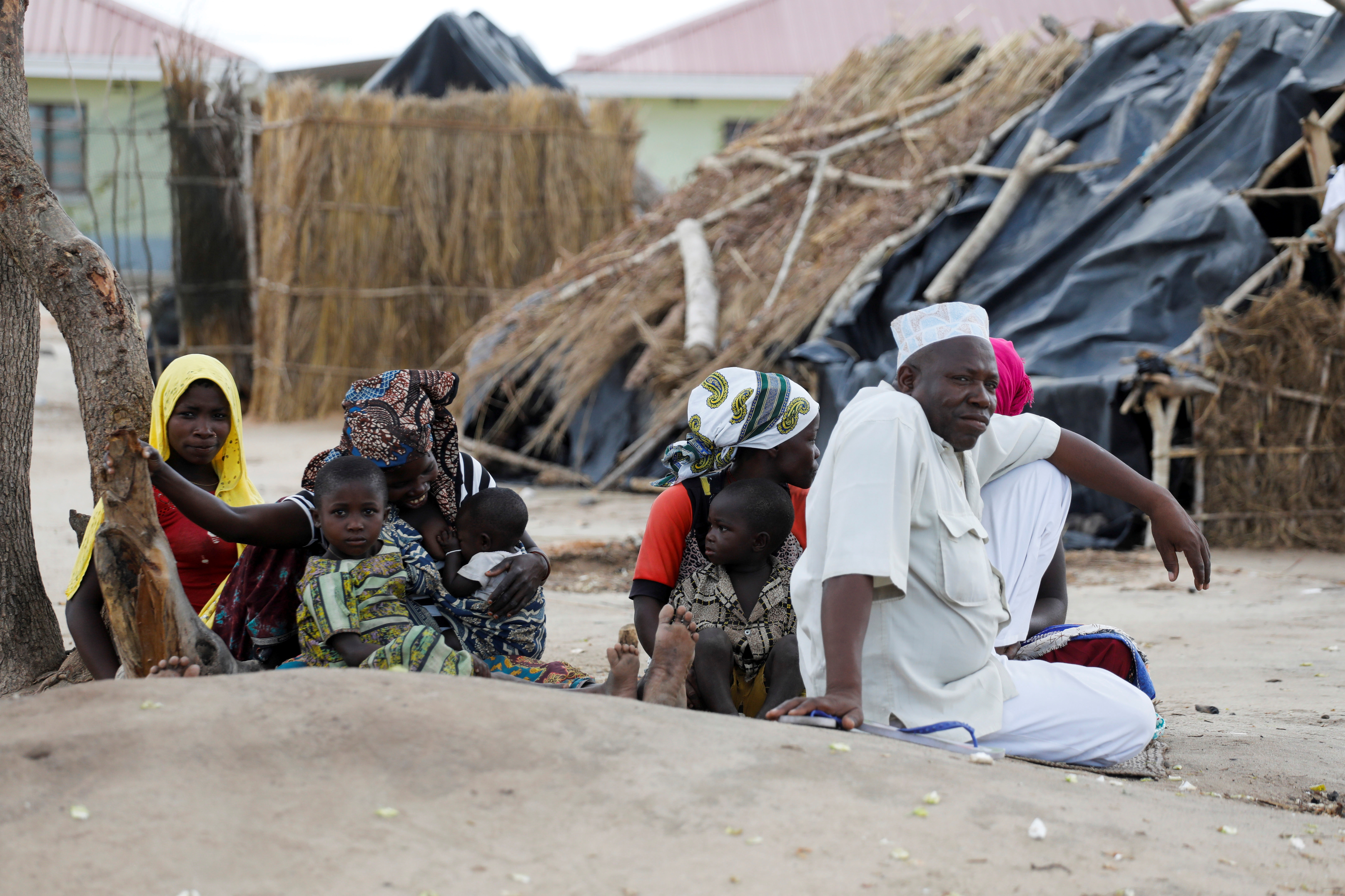 A family displaced by fighting sit inside a camp for the internally displaced in the town of Quitunda, Mozambique
