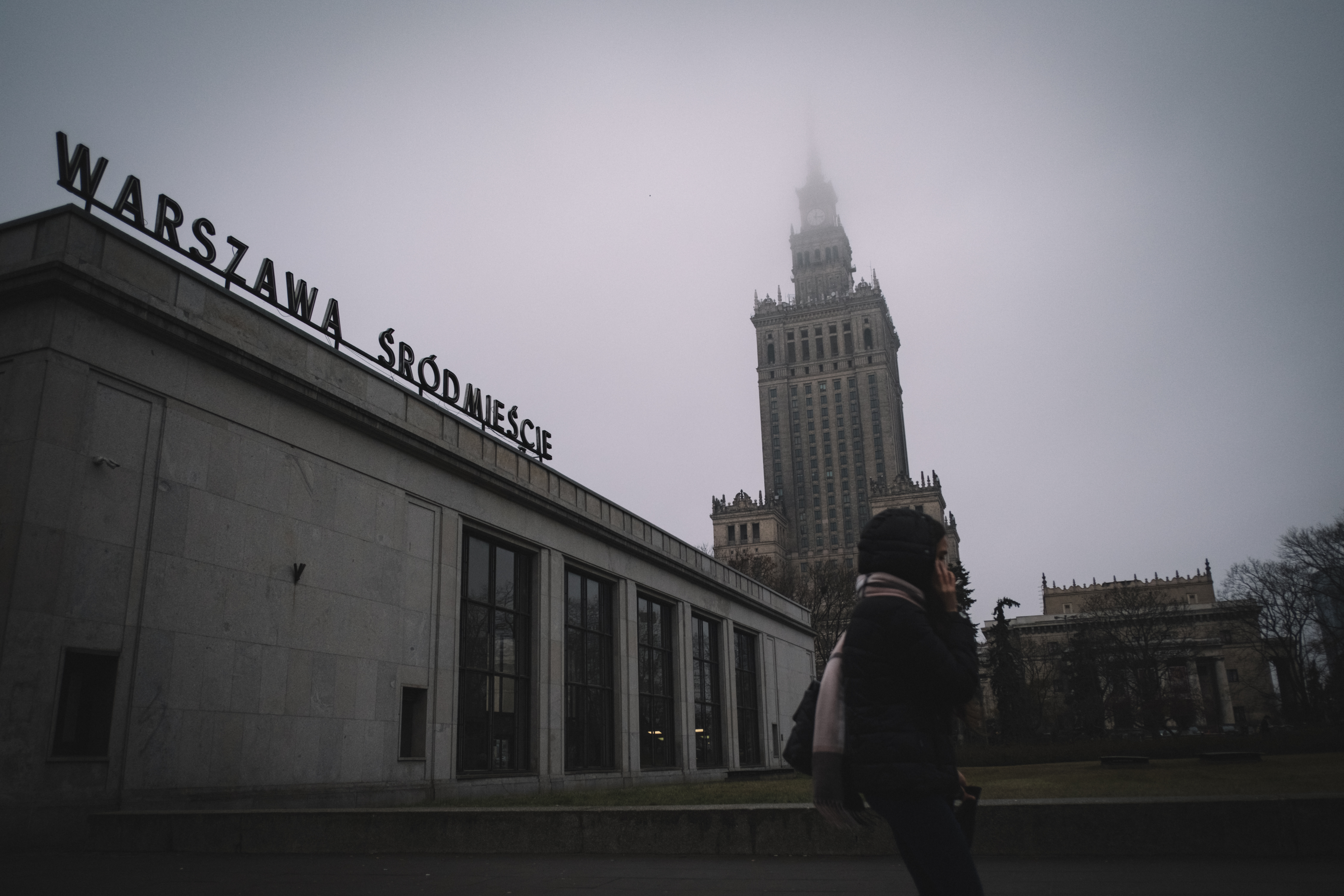 A young woman walks near by the Palace of Culture and Sciences in downtown Warsaw