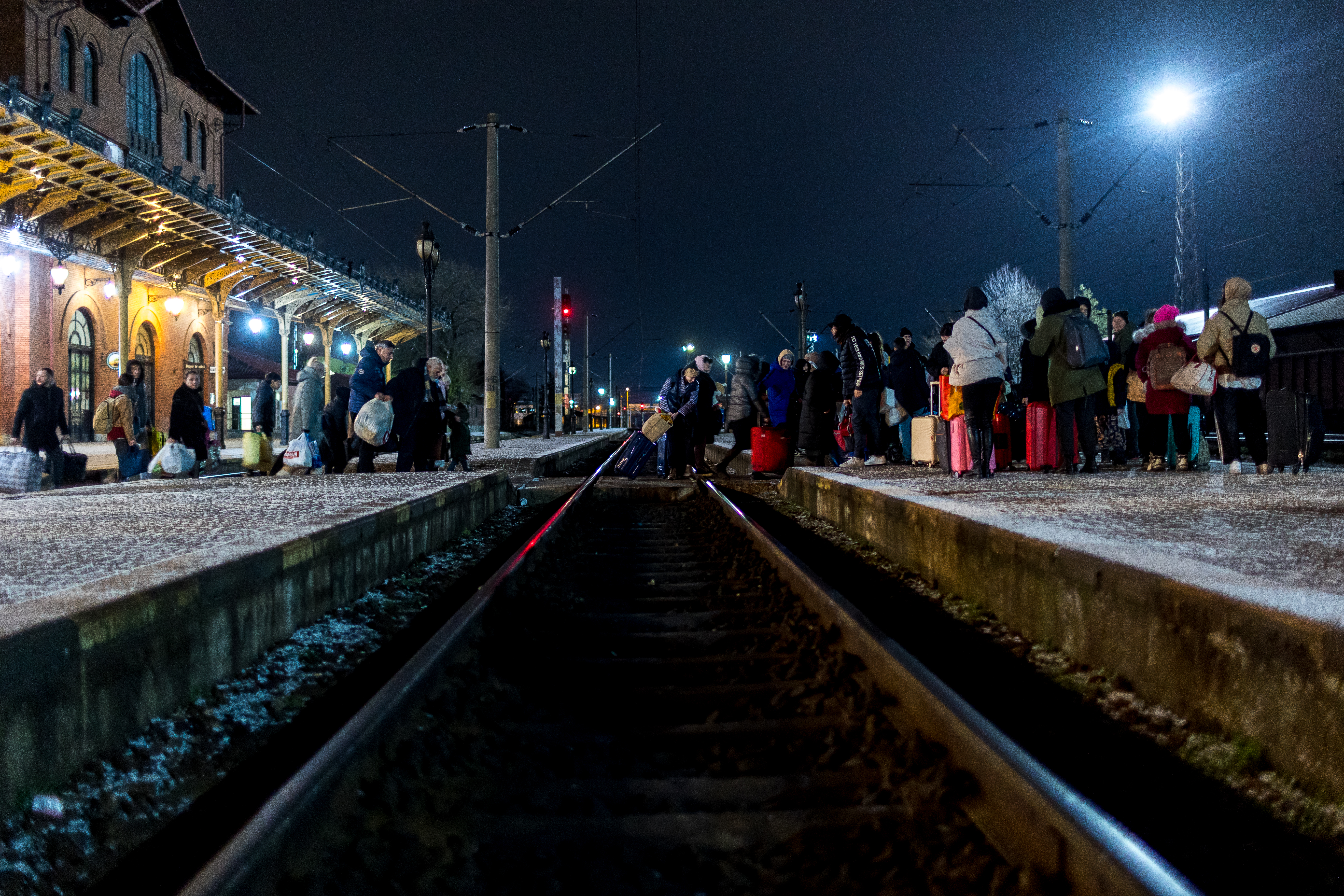 People wait on a train platform