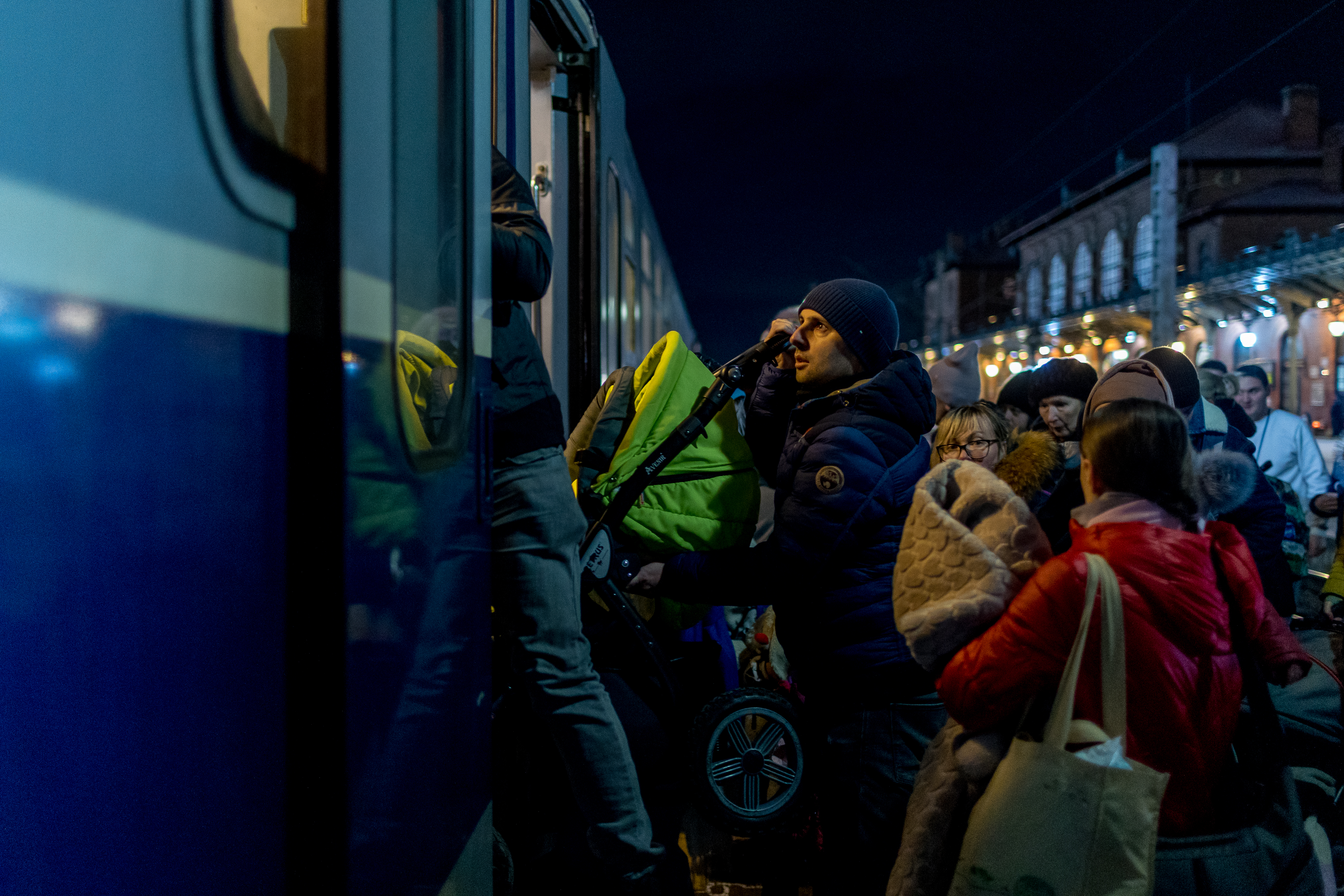 People wait to board a train