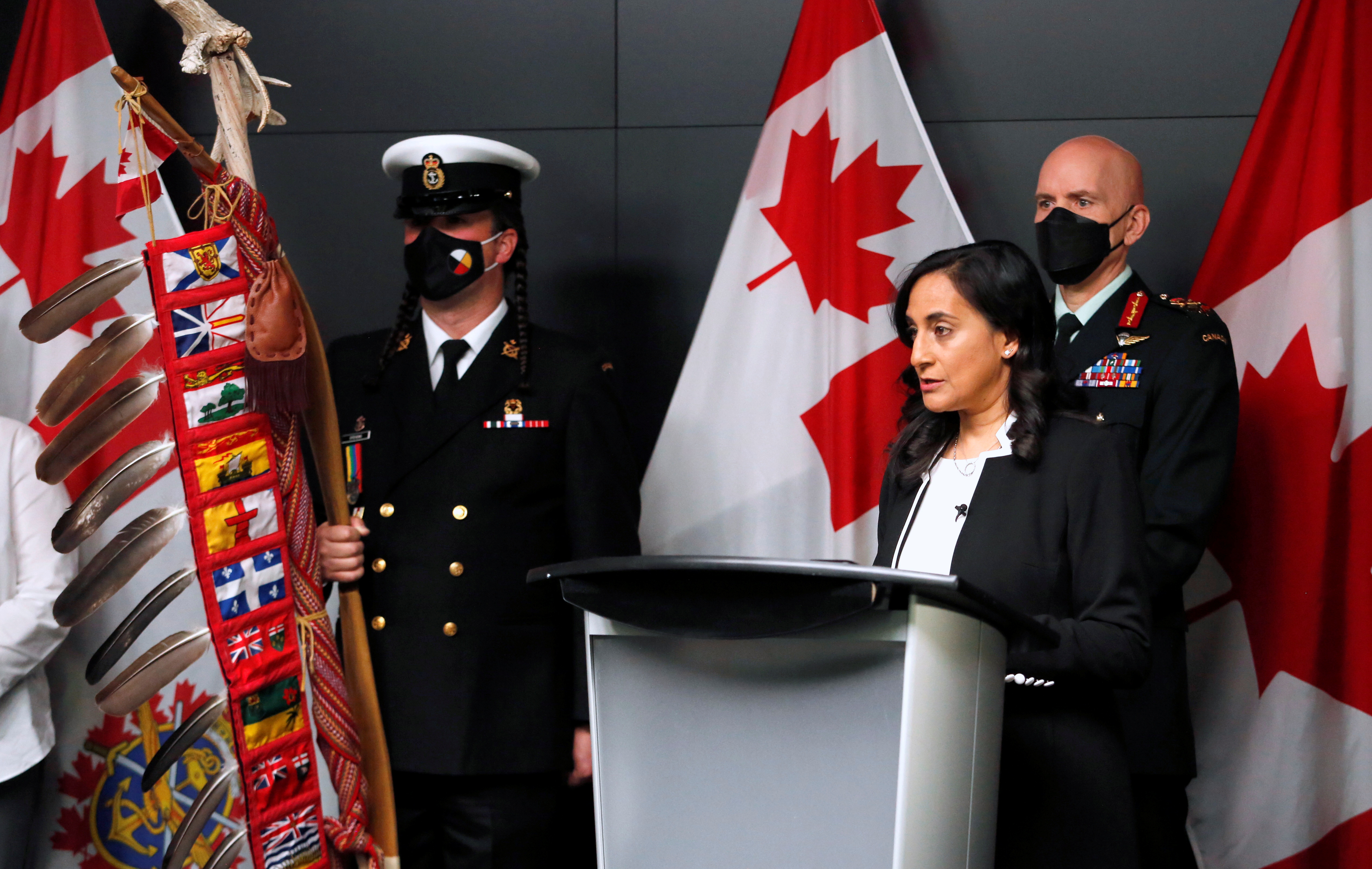 Canada's Defence Minister Anita Anand speaks at a podium