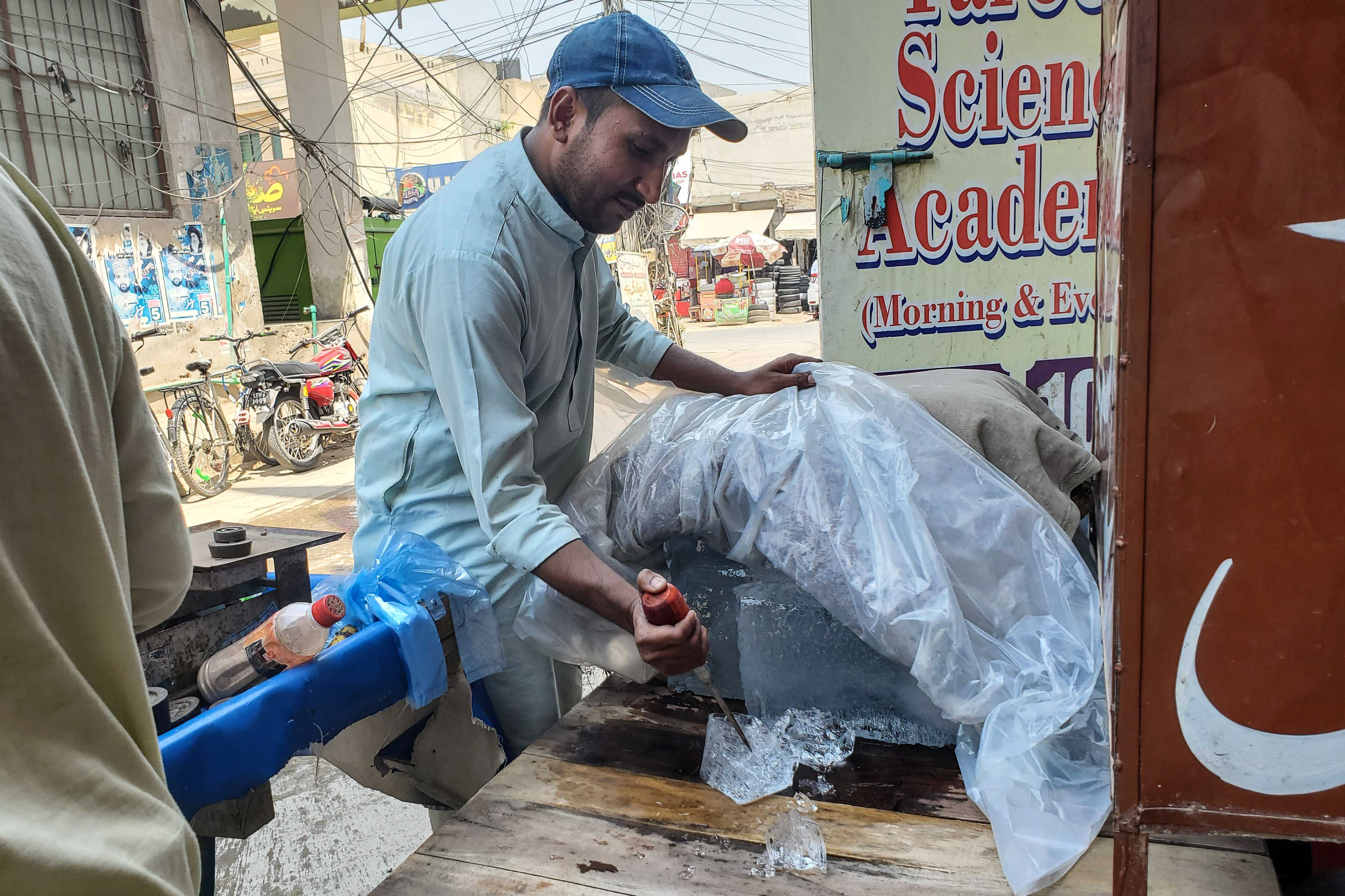 Muahmmad Zubair chopping ice to stay cool