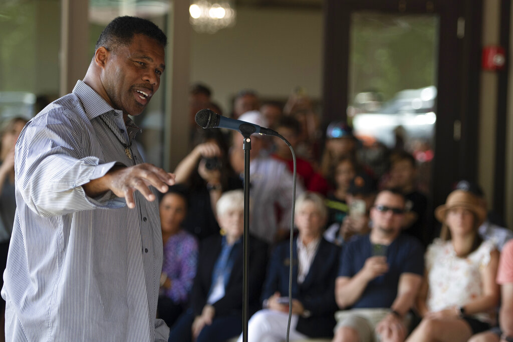 Republican Senate candidate Herschel Walker speaks to supporters during a campaign stop, May 14, 2022, in Ellijay, Ga.