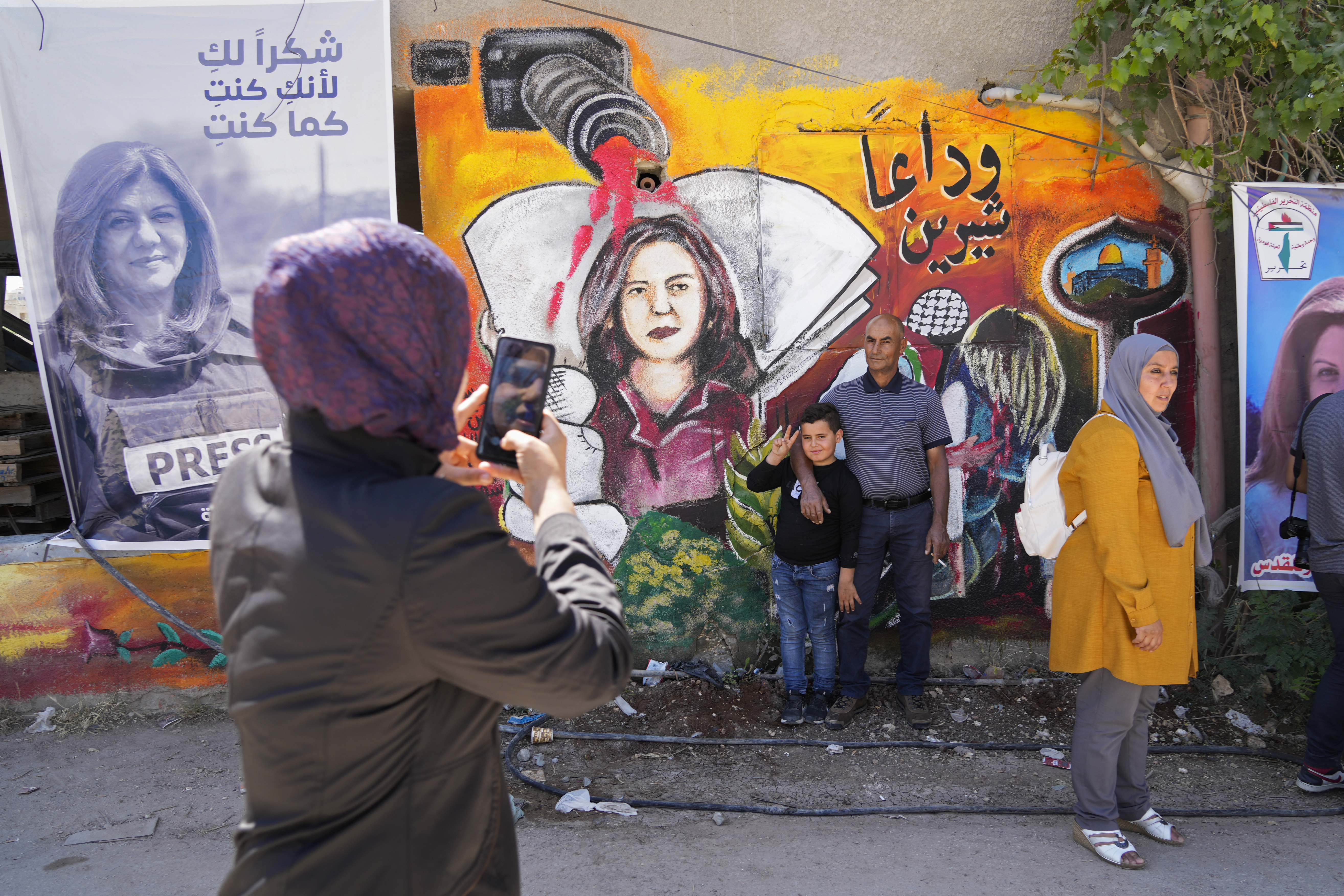 Palestinians visit the site where Shireen Abu Akleh was shot and killed, in the occupied West Bank city of Jenin on May 18, 2022 [Majdi Mohammed/AP]