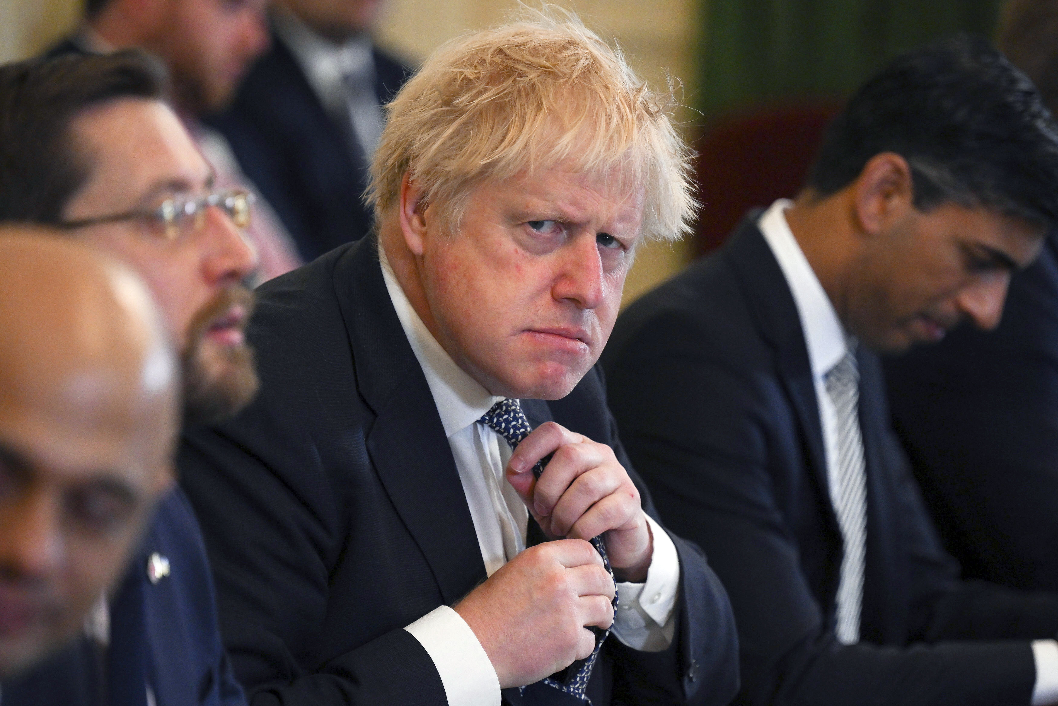 Britain's Prime Minister Boris Johnson adjusts his tie