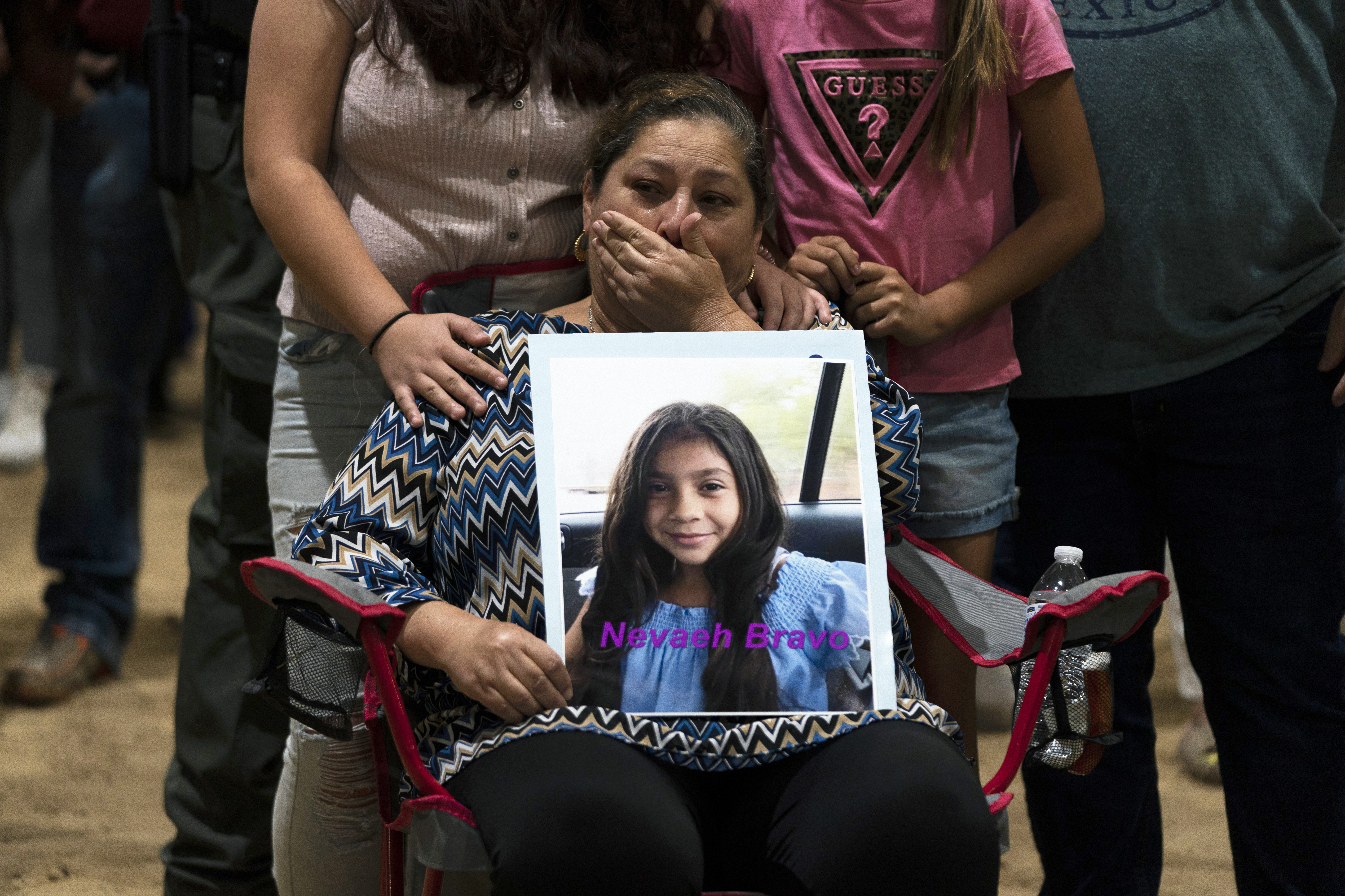 Esmeralda Bravo, 63, sheds tears while holding a photo of her granddaughter, Nevaeh.