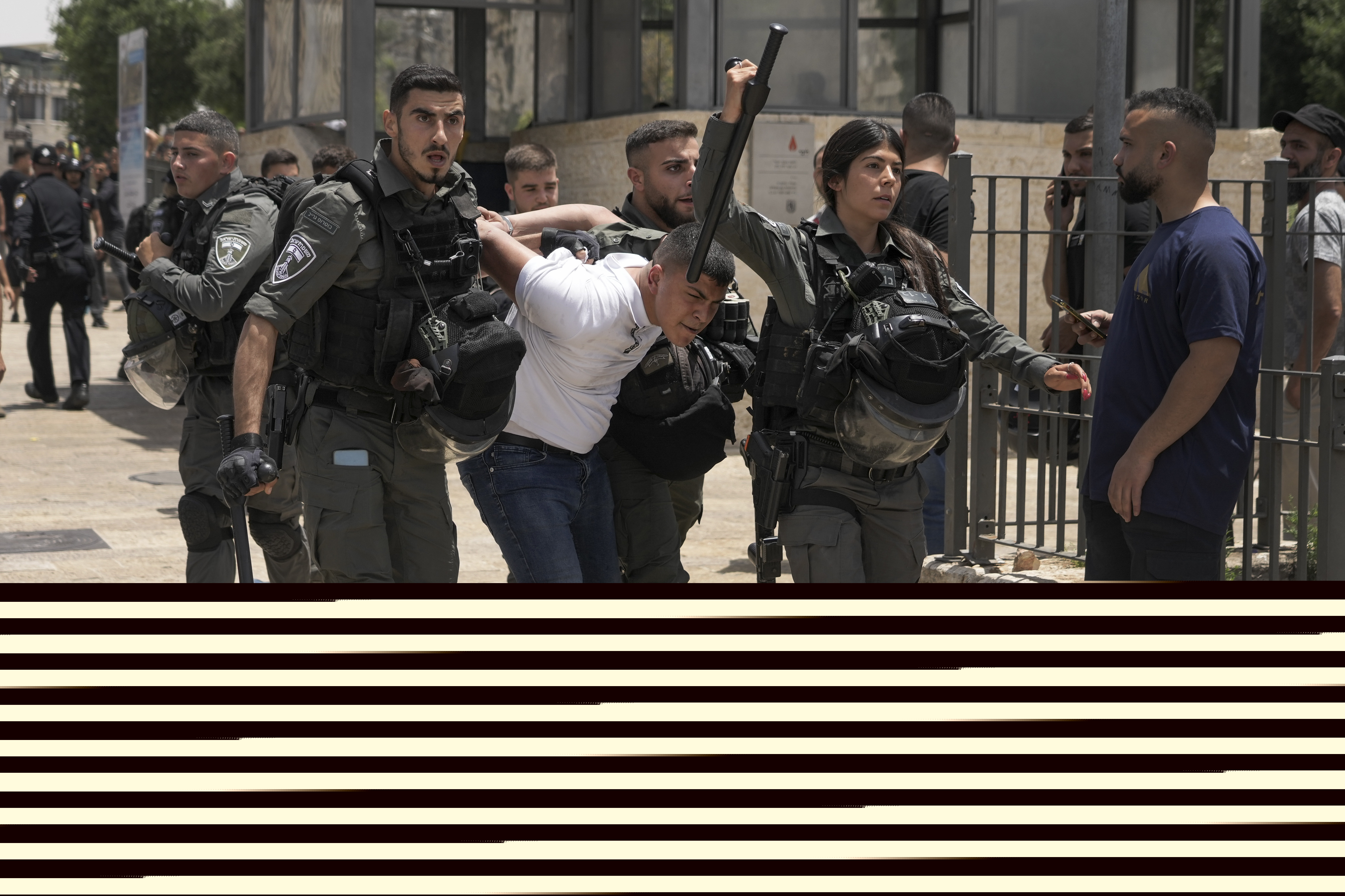Members of Israeli security forces detain a Palestinian protester near Damascus Gate outside Jerusalem's Old City.