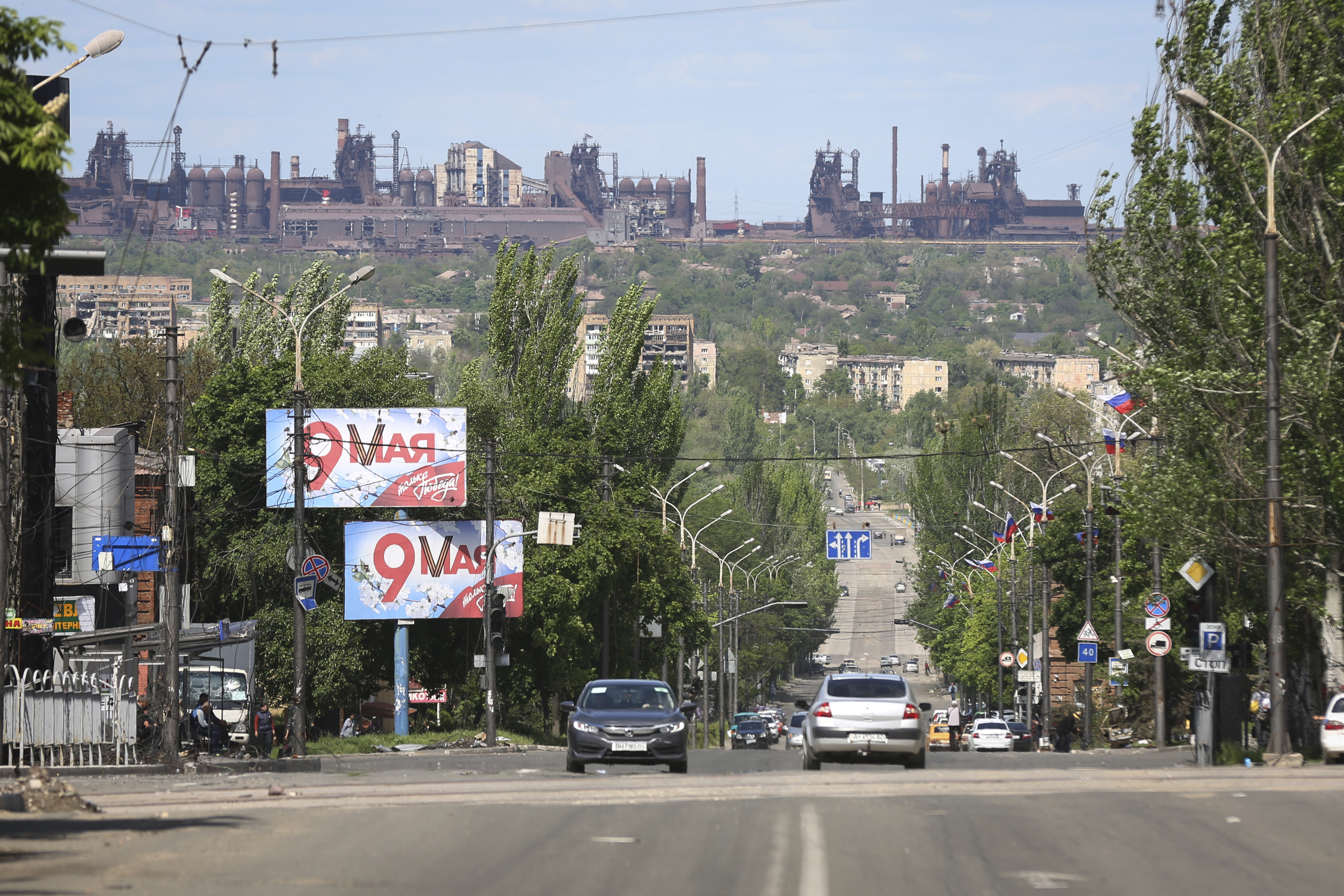 A view of a street in Mariupol, captured by Russian forces, with the Azovstal steel plant in the background.