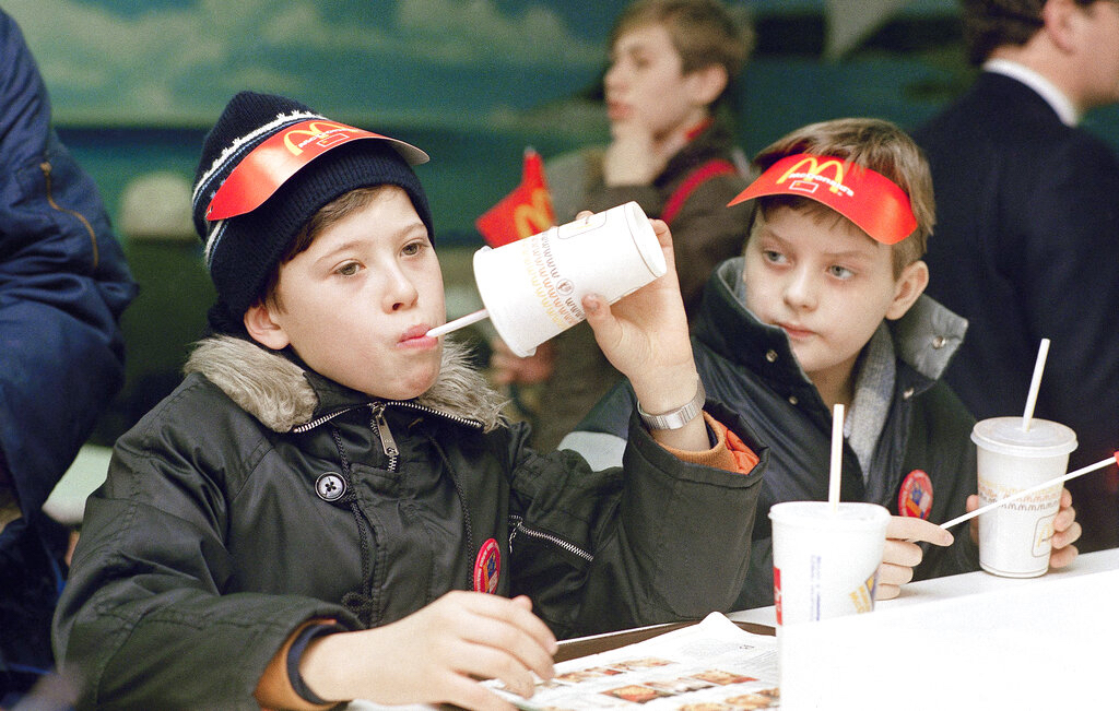 Young Muscovites checks out a new taste sensation for the Soviet Union, hamburgers and soft drinks in Moscow on Jan. 31, 1990