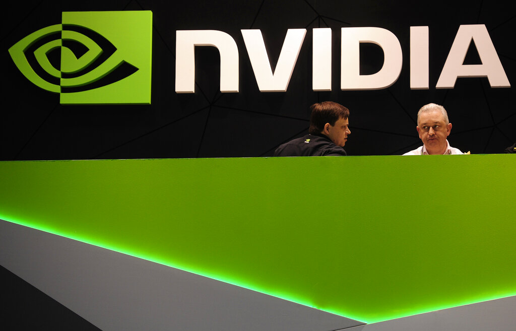People gather in the Nvidia booth at the Mobile World Congress mobile phone trade show in Barcelona, Spain