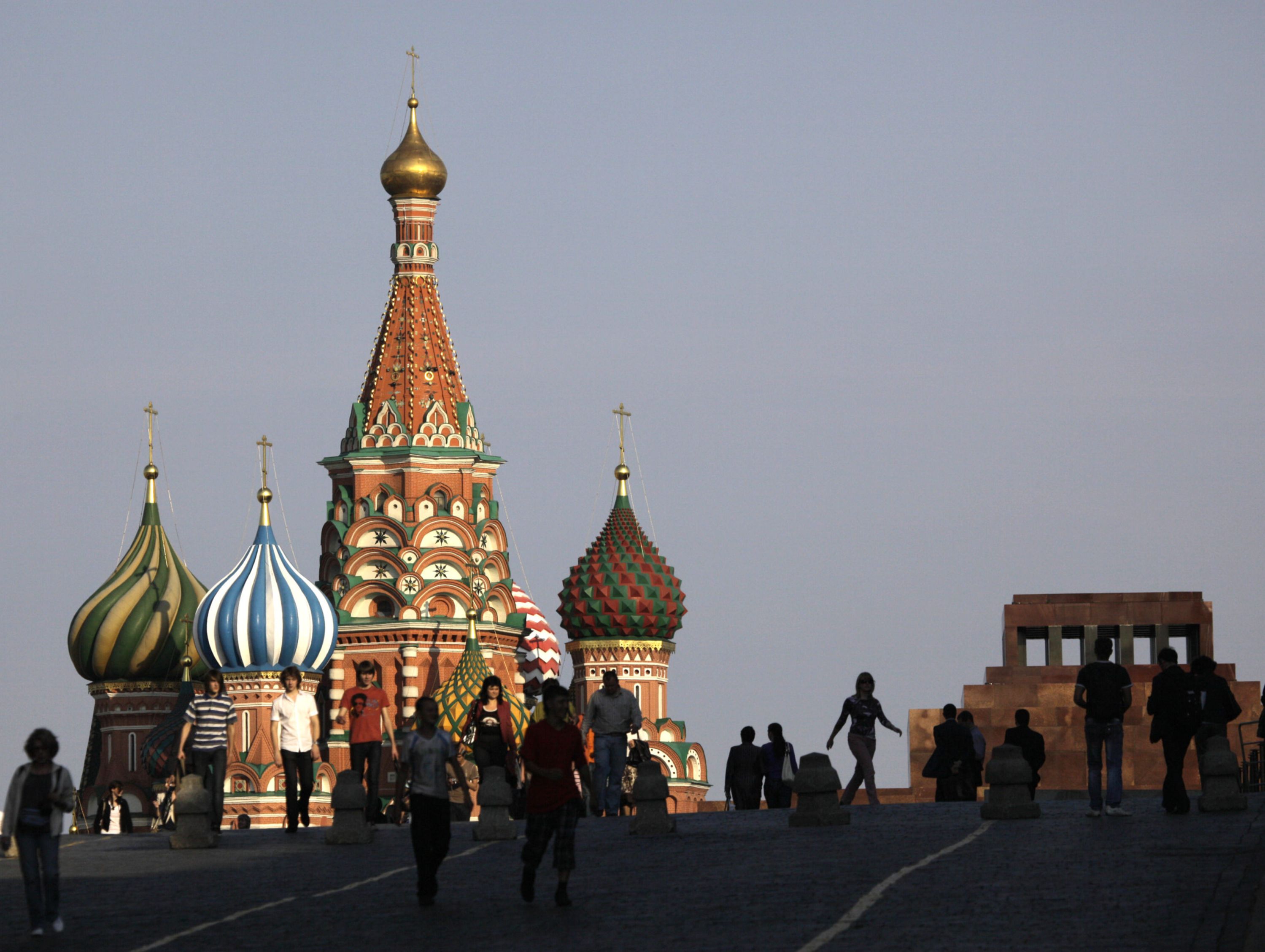 Pedestrians walk past St. Basil's Cathedral in Red Square in Moscow, Russia