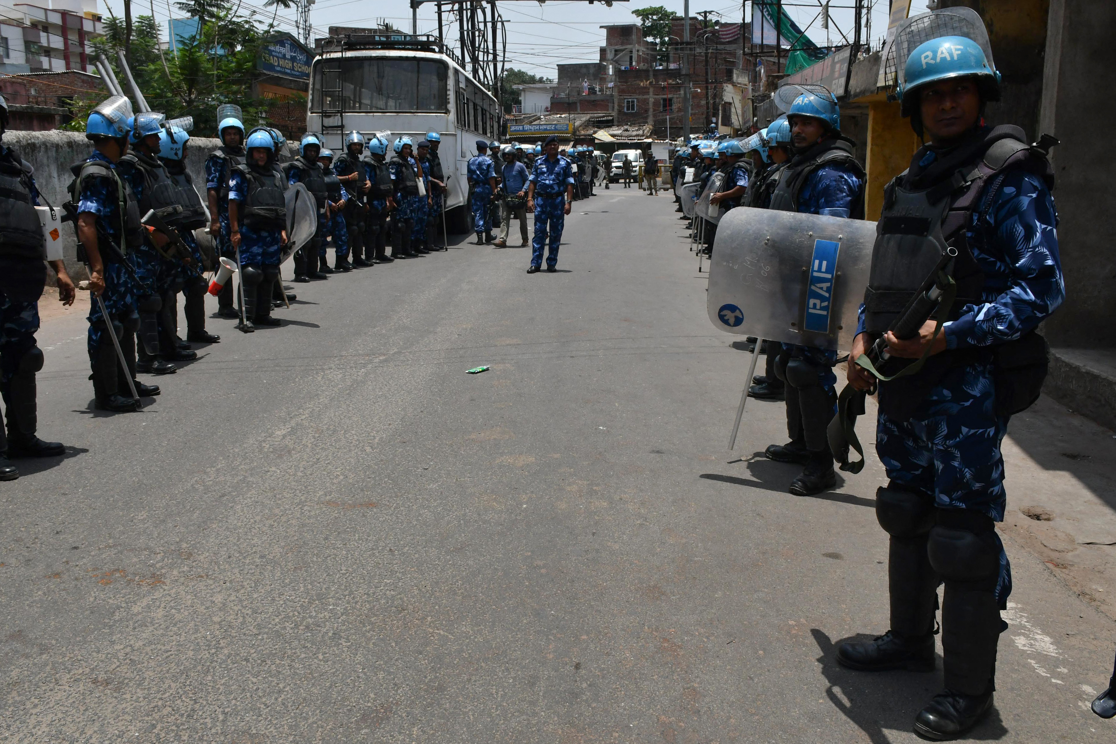 Rapic Action Force personnel stand guard along a road during a partial curfew imposed following violent demonstrations against Bharatiya Janata Party former spokeswoman Nupur Sharma's remarks on the Prophet Mohammed, in Ranchi