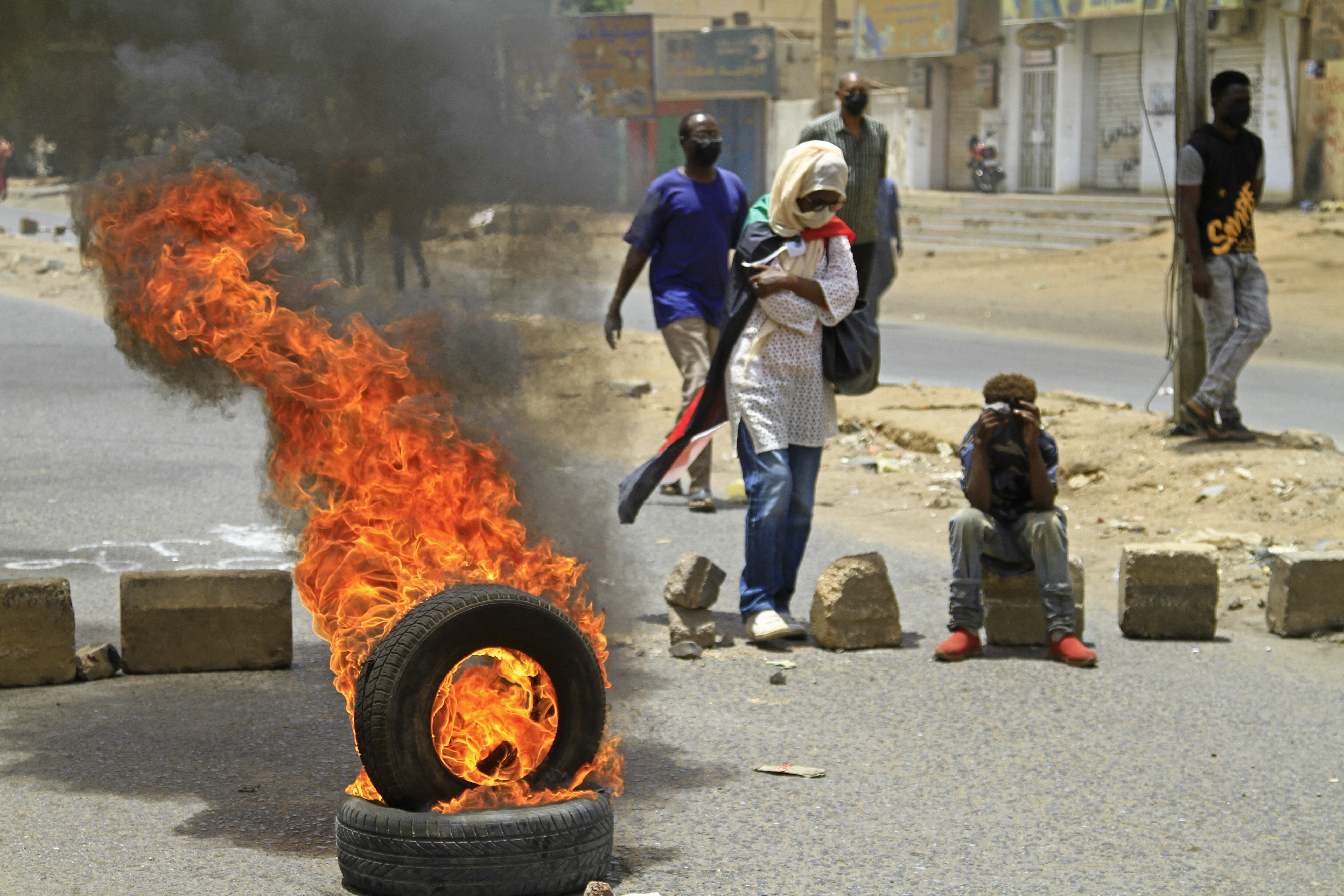 Sudanese anti-coup protesters burn tyres amid clashes with security forces in Omdurman, the capital Khartoum's twin city, on June 30, 2022 [AFP]