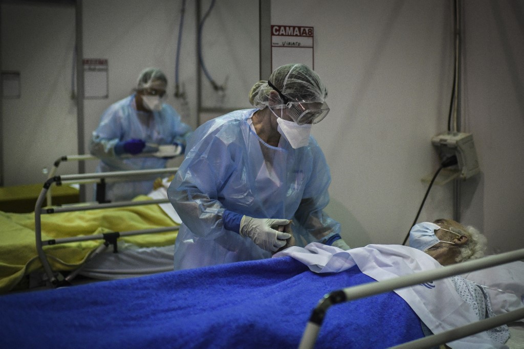 Healthcare workers attend to patients at the Portimao Arena sports pavilion converted in a field hospital for Covid-19 patients at Portimao, in the Algarve region