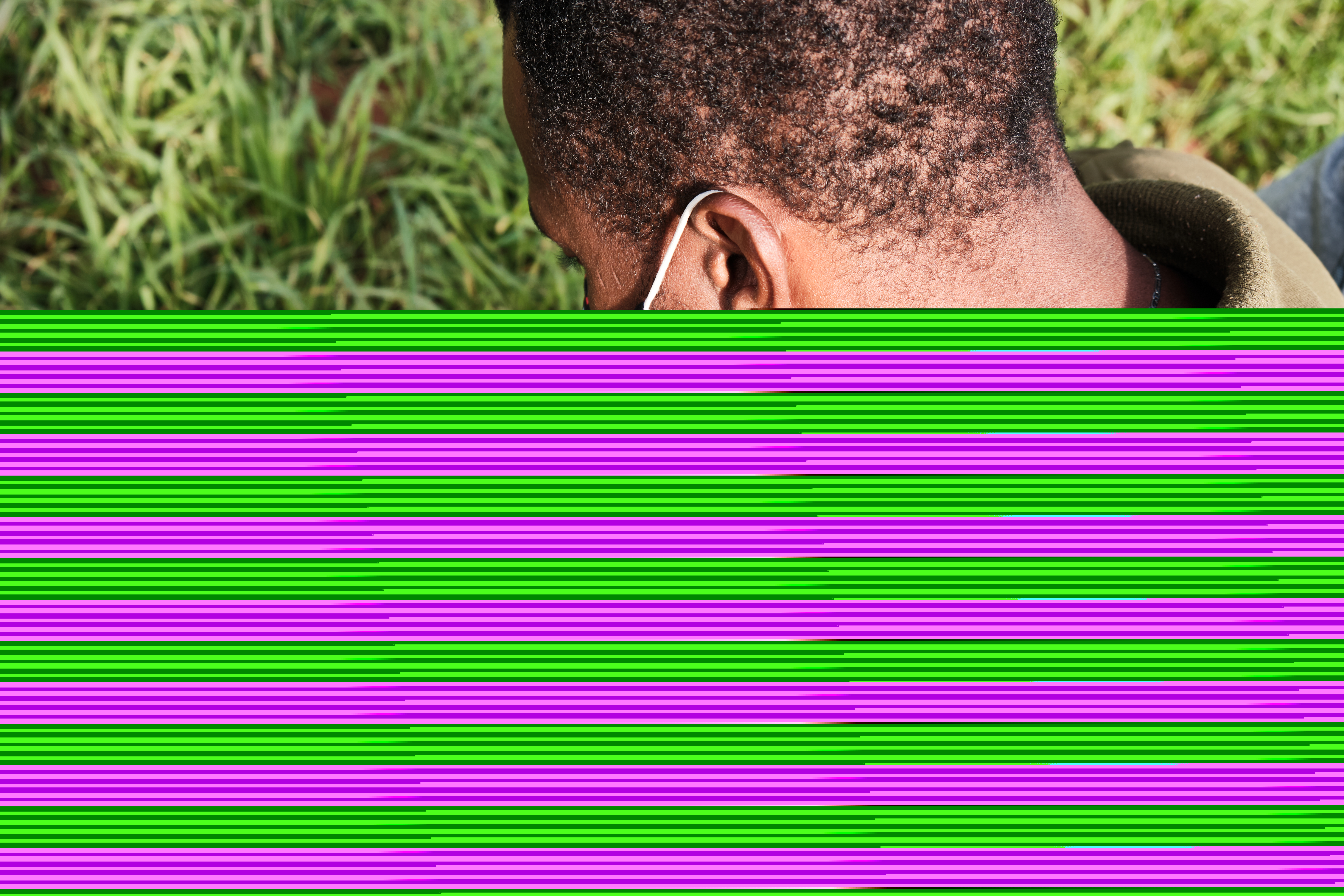 A photo of Mamadou, 28, from Mali, writing a note in Pular