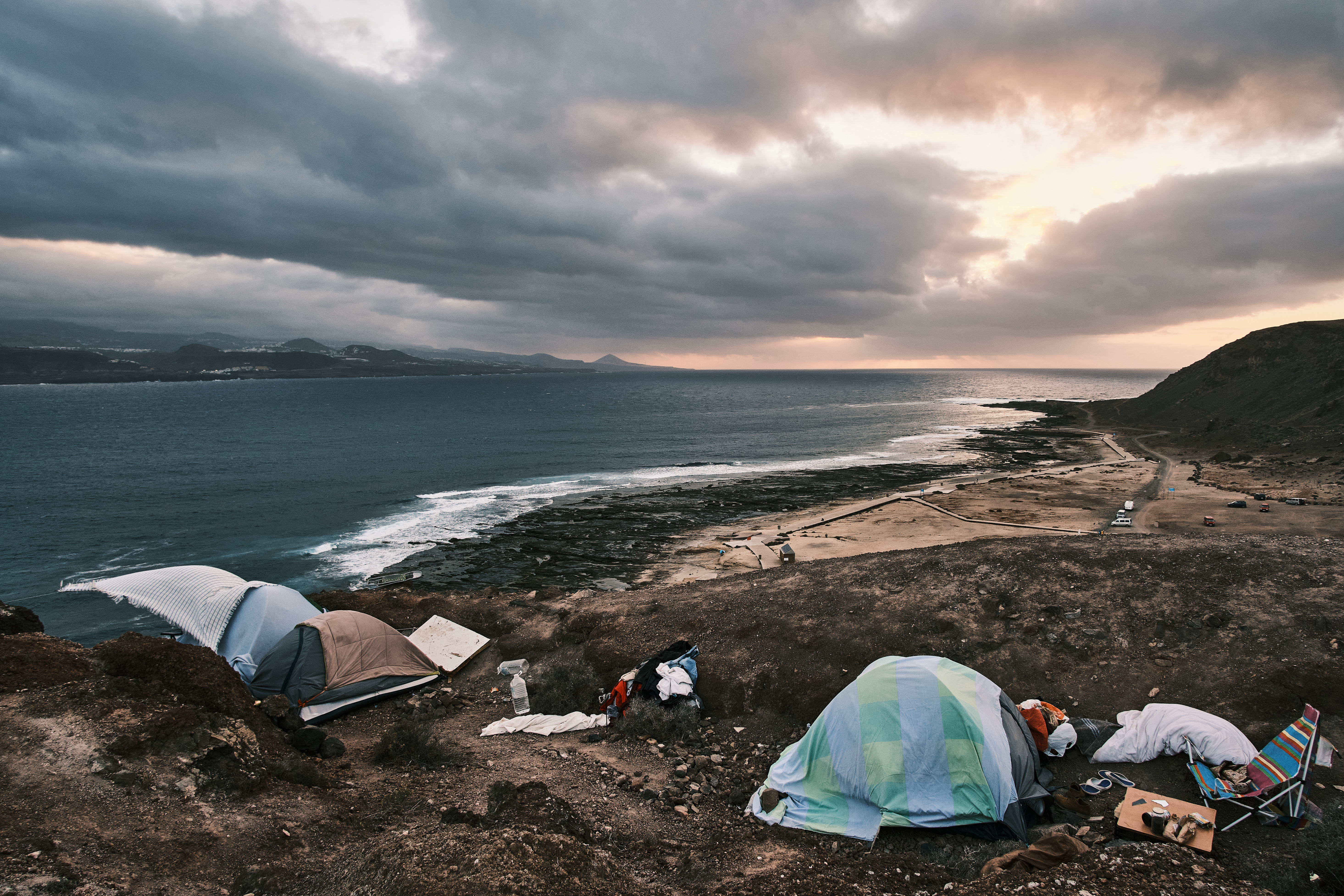 A photo of a makeshift shelter by the sea.