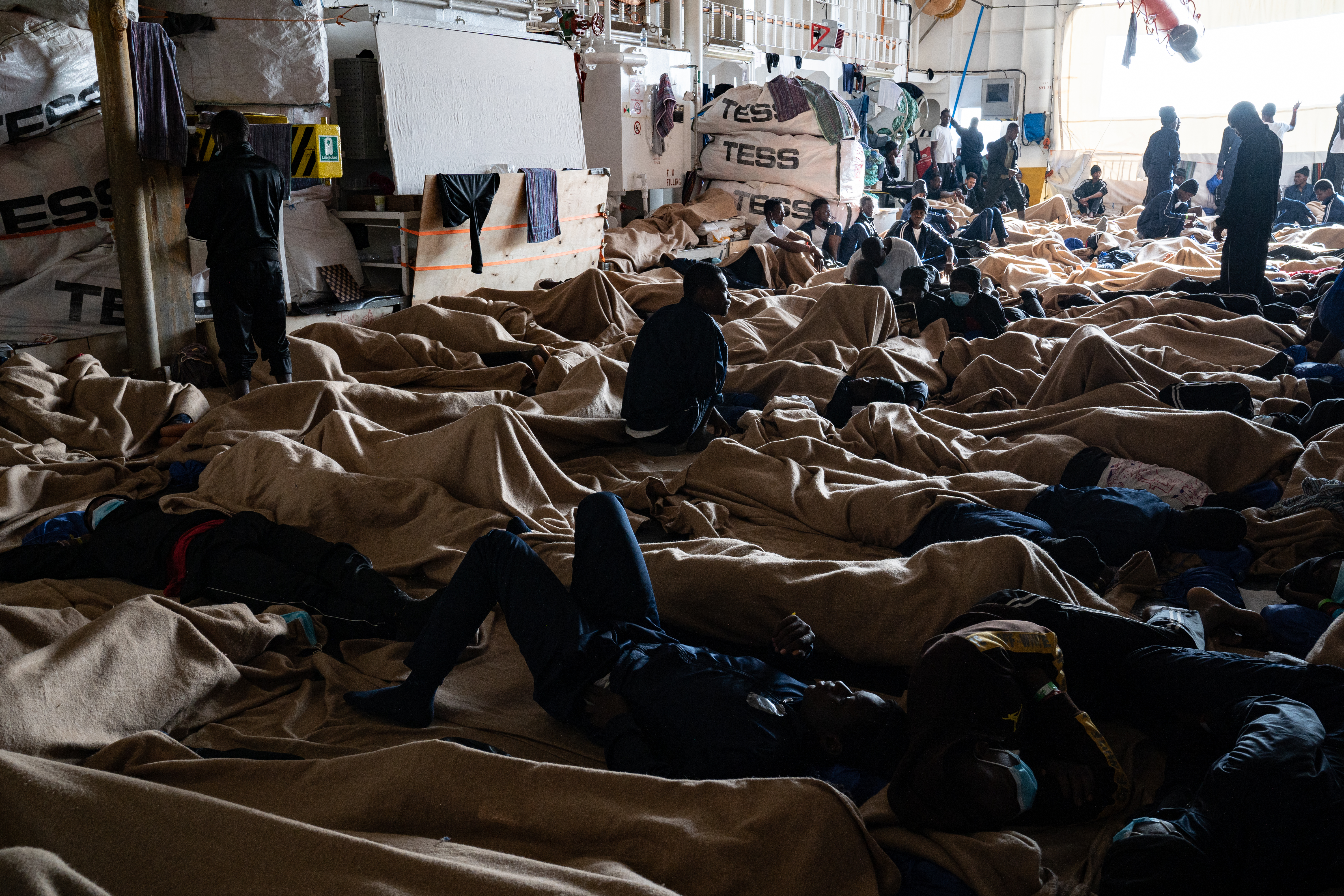 Survivors wait on the decks of a rescue ship in the Med Sea