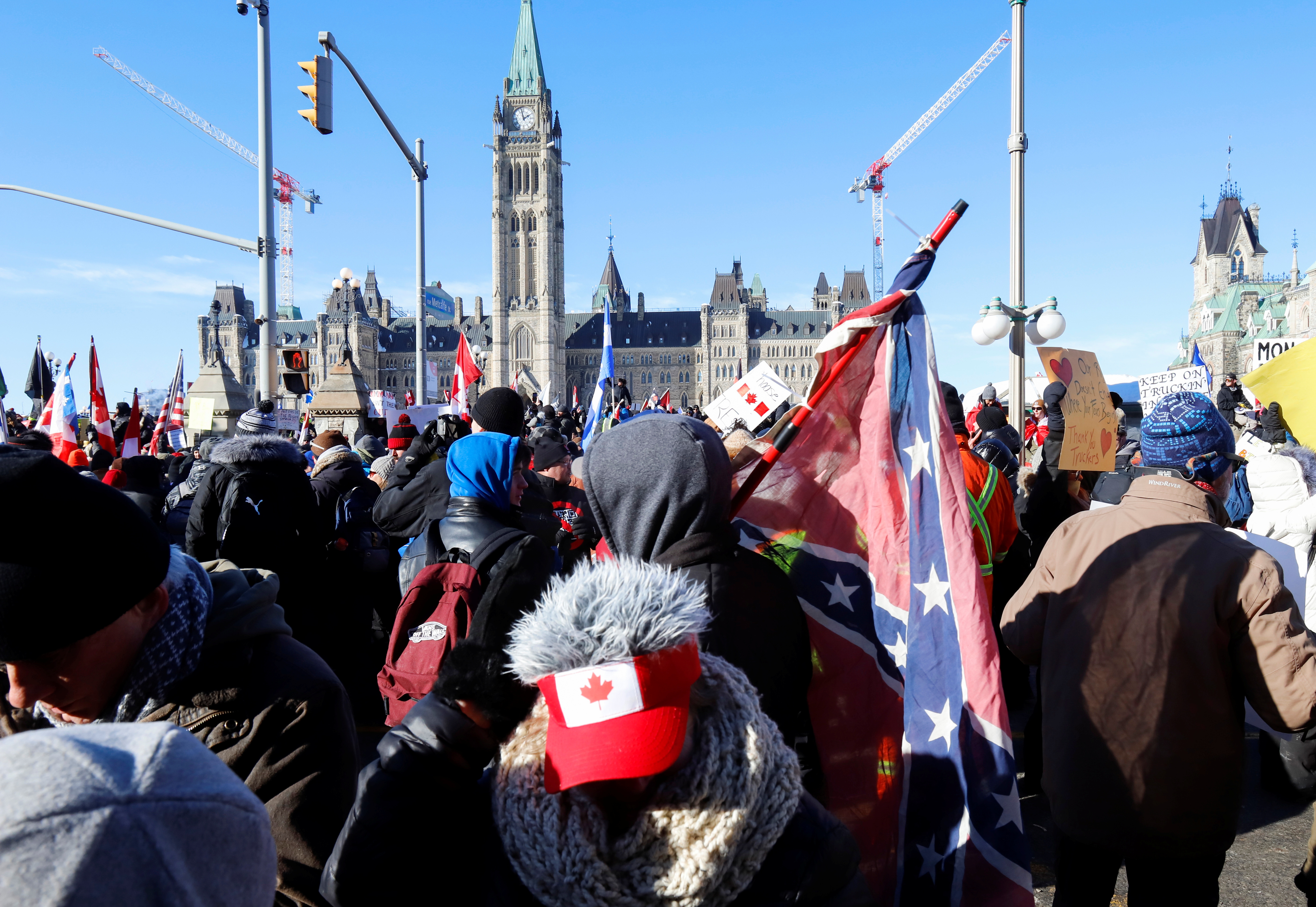 A person carries a Confederate battle flag at Parliament Hill in Ottawa, Canada