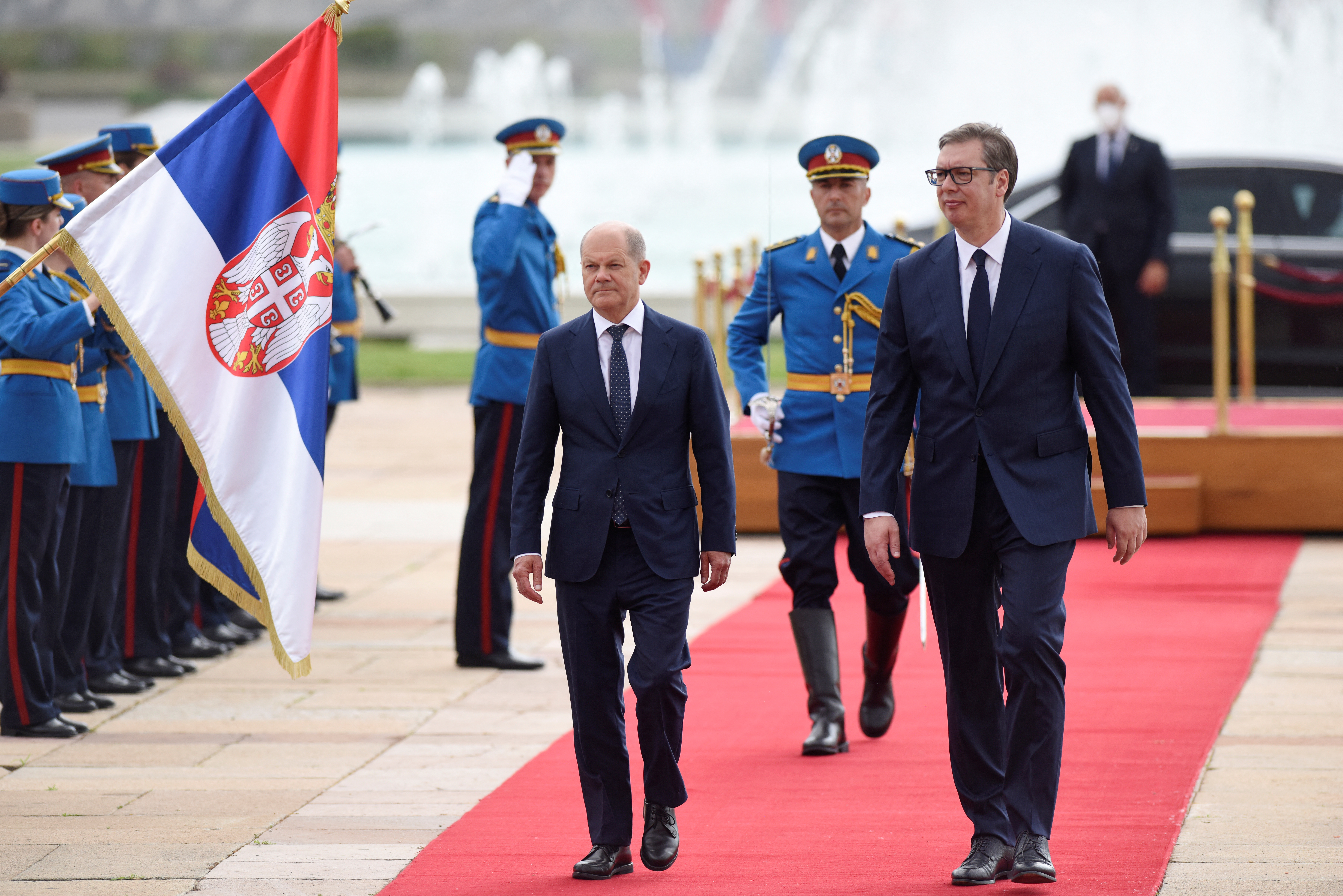 German Chancellor Olaf Scholz receives an honour guard, while walking with Serbian President Aleksandar Vucic, in Belgrade, Serbia