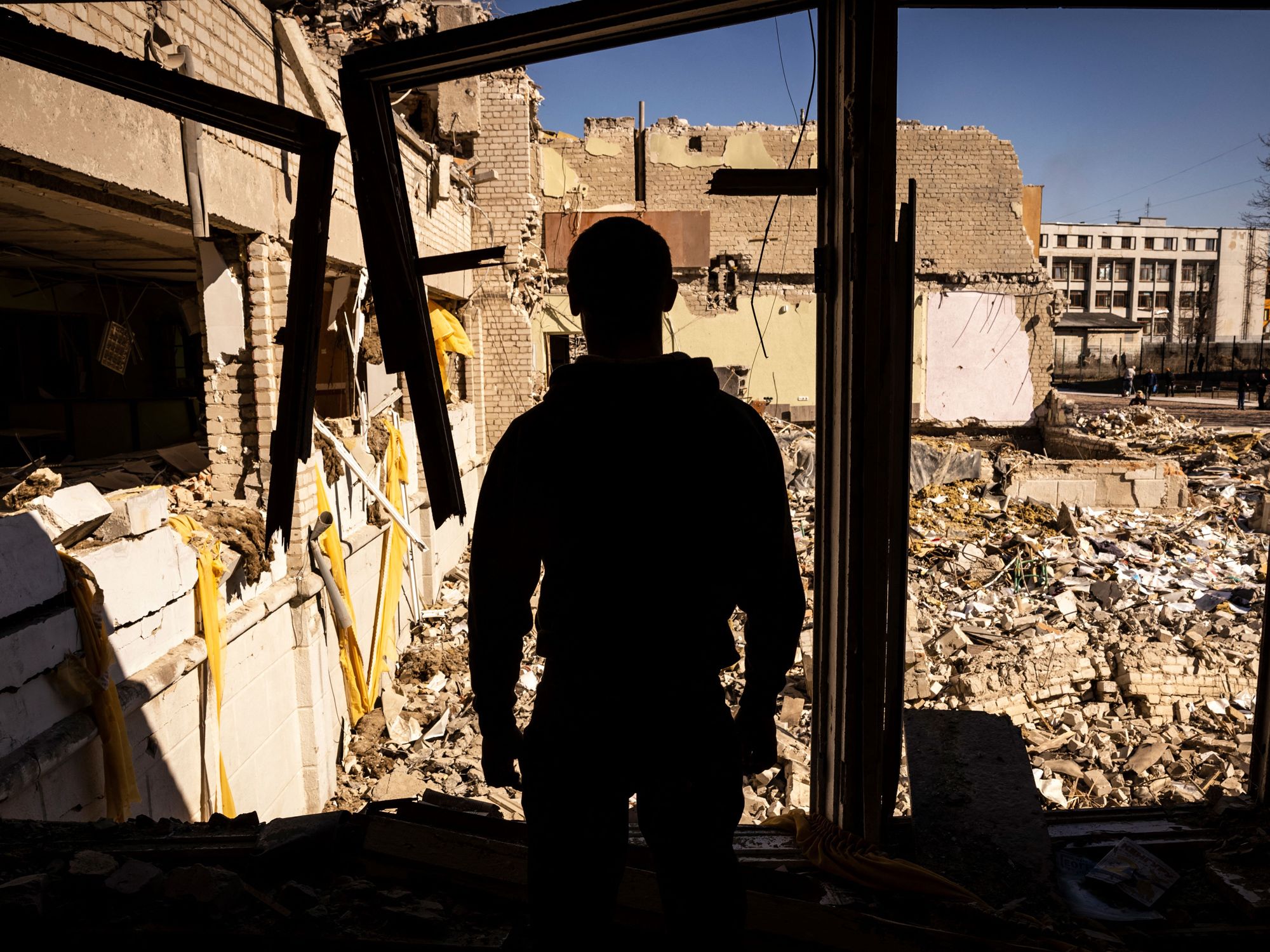 A man stands inside of a damaged school in the city of Zhytomyr, northern Ukraine