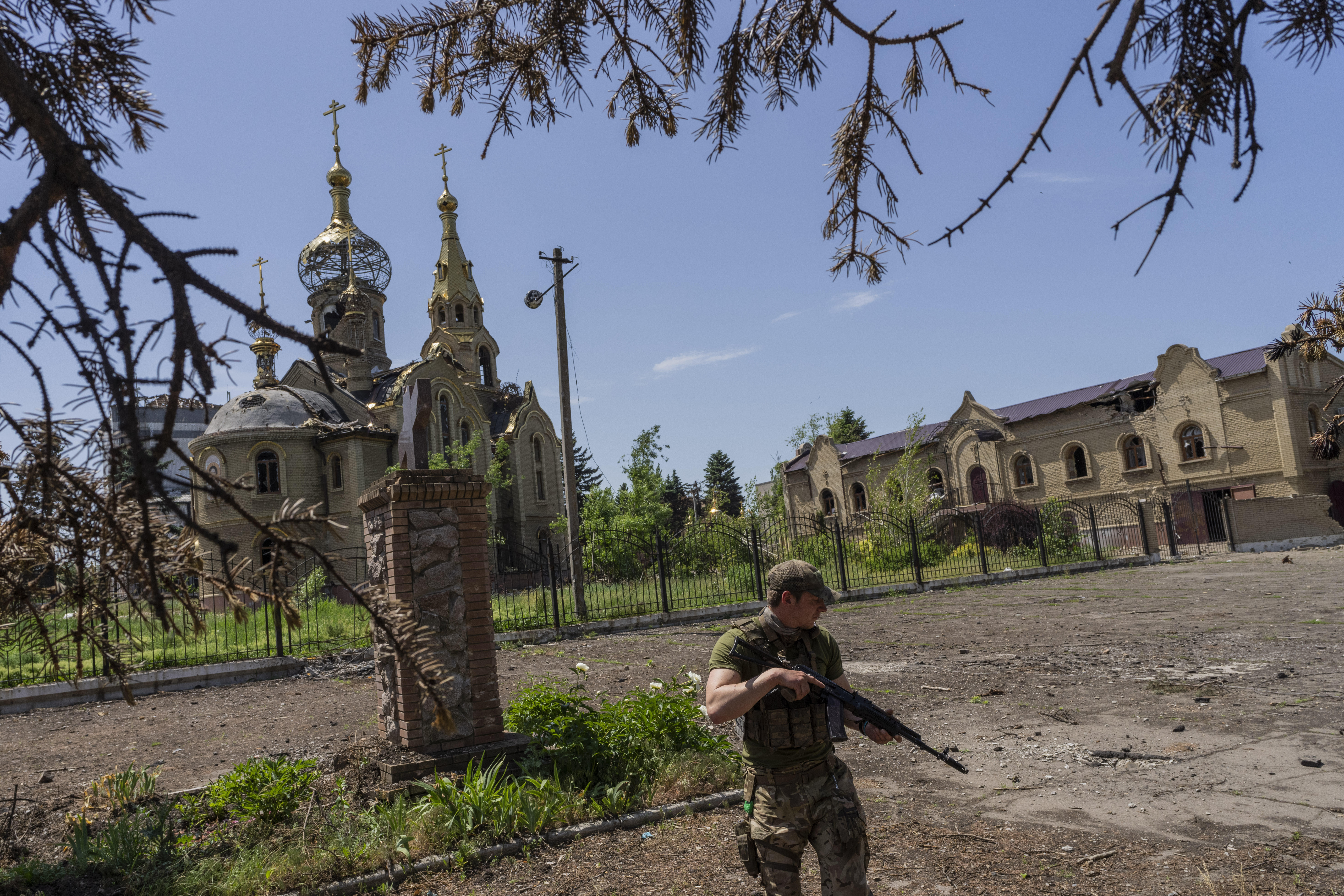 A Ukrainian serviceman patrols a village near the frontline in the Donetsk oblast region, eastern Ukraine,