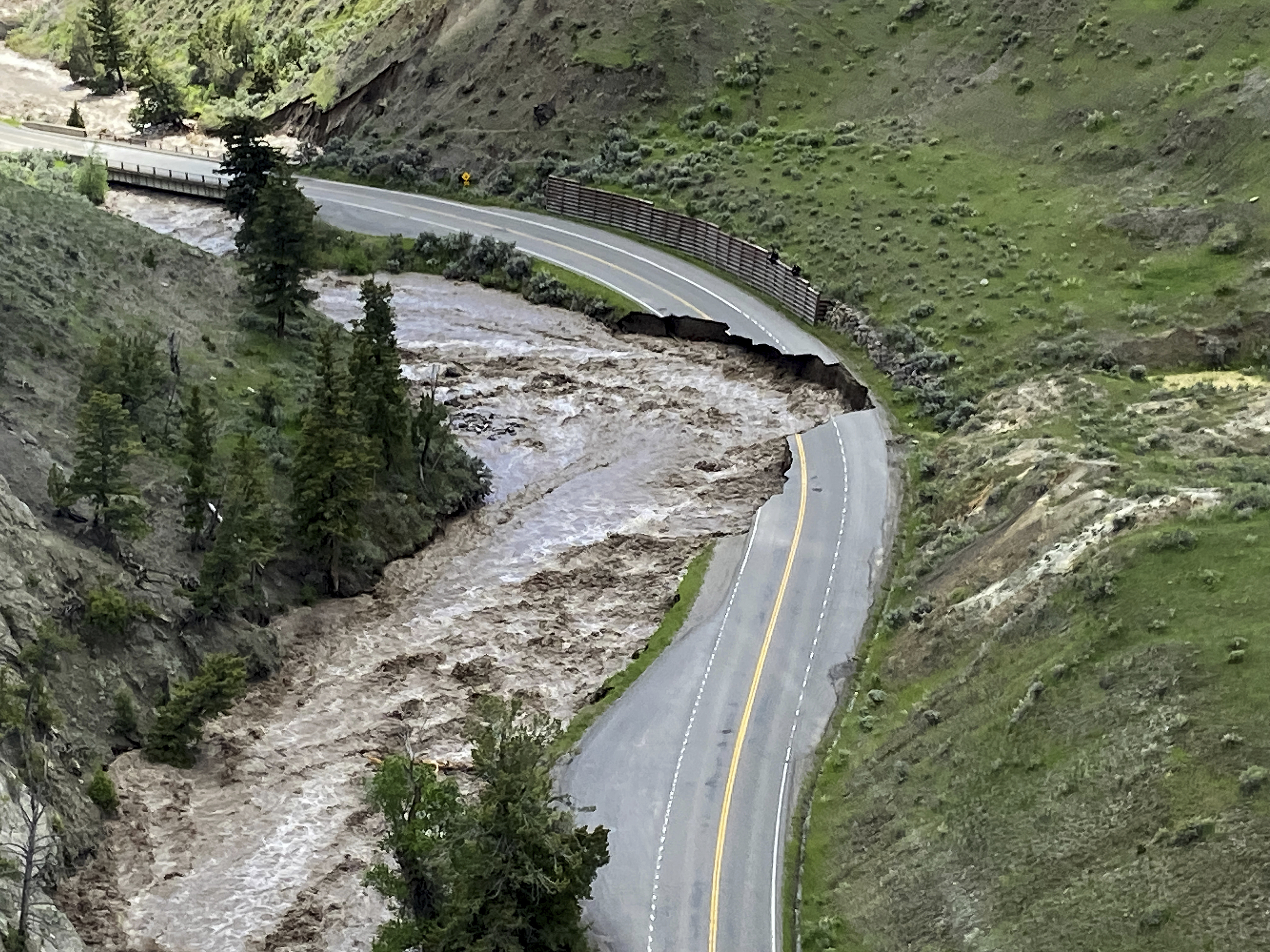 This aerial photo provided by the National Park Service shows a washed out road at North Entrance Road