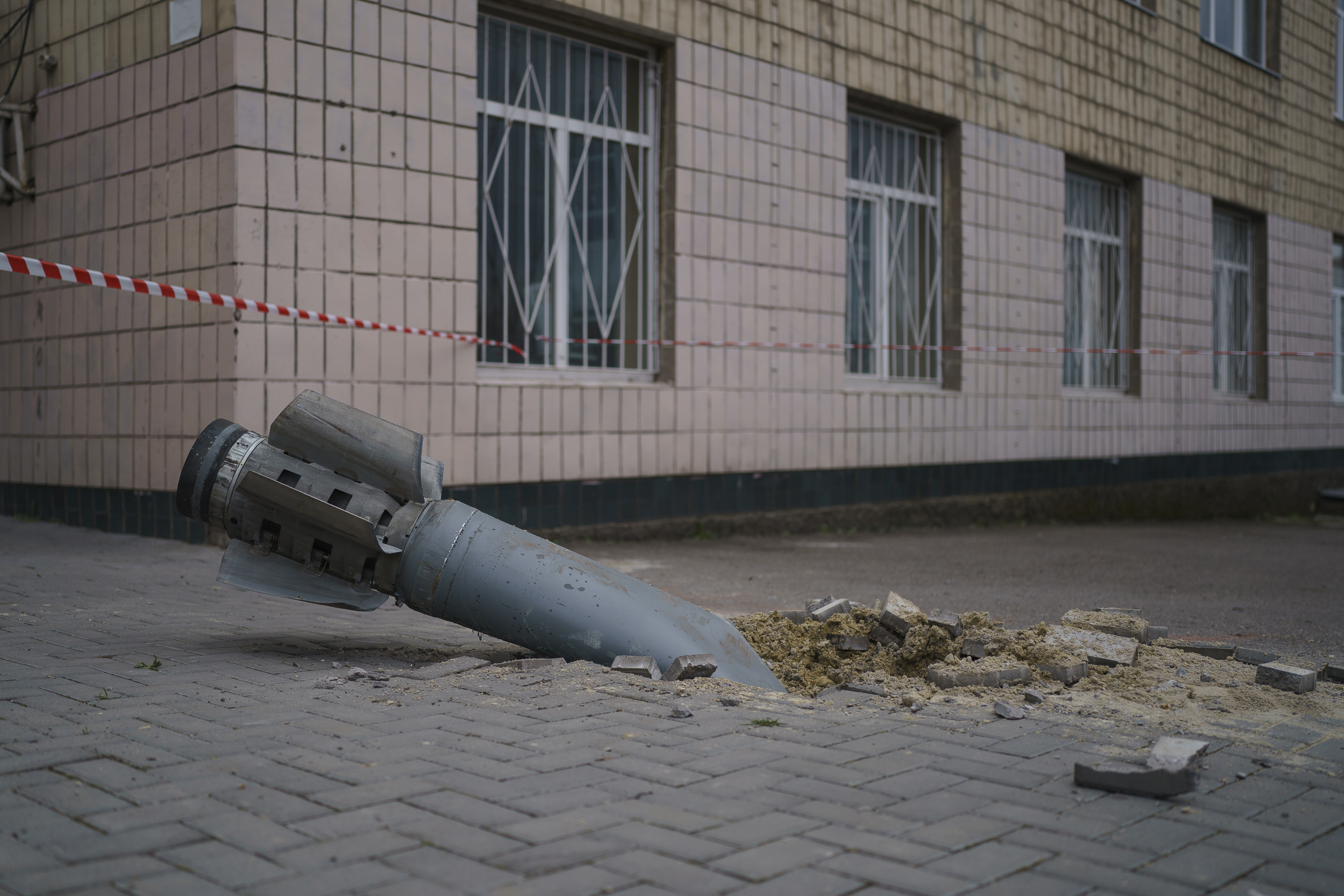 An unexploded missile stuck in the ground in the city centre of Mykolaiv.