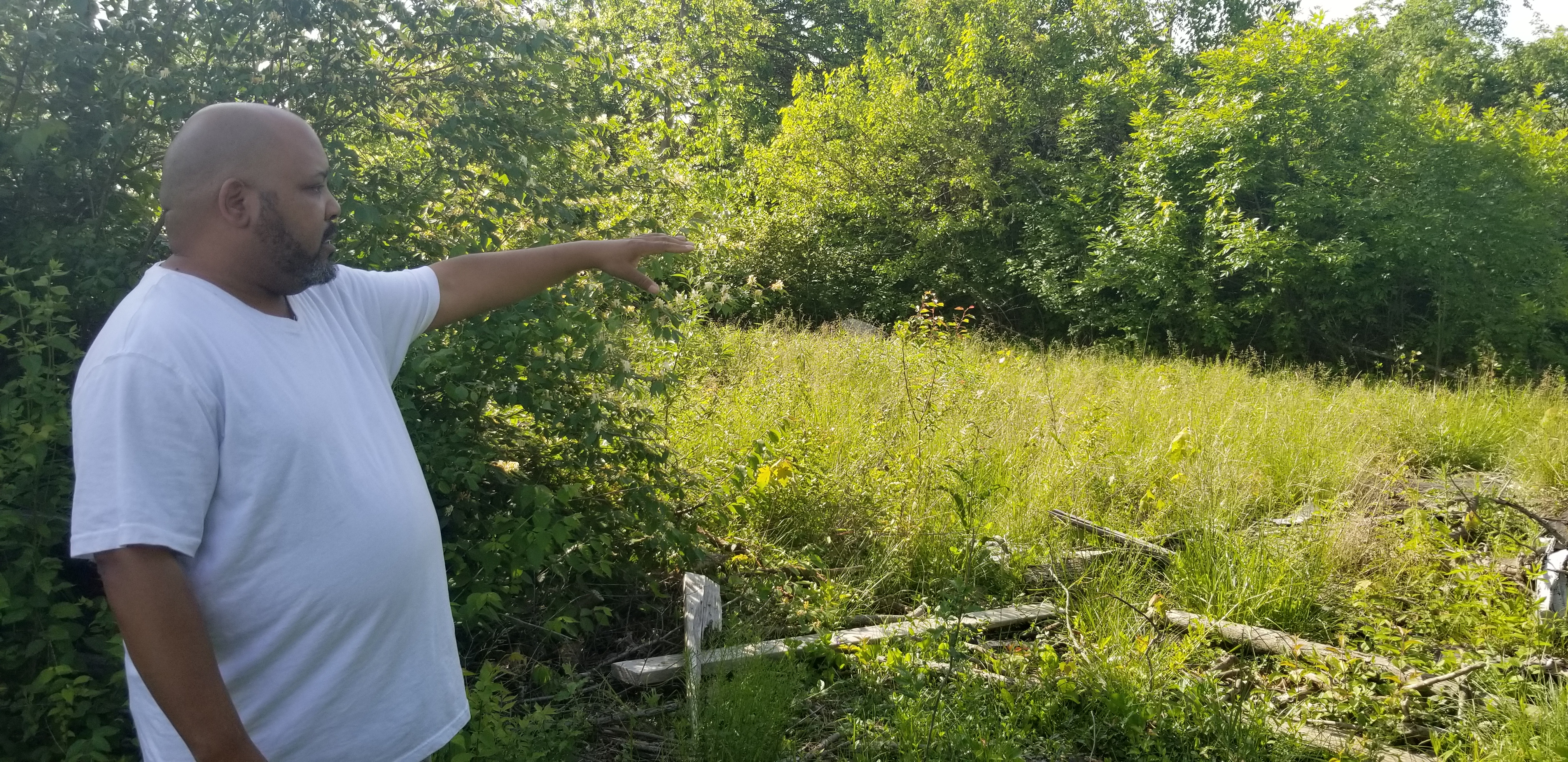 Derrick Stephens showing tree damage from a tornado.