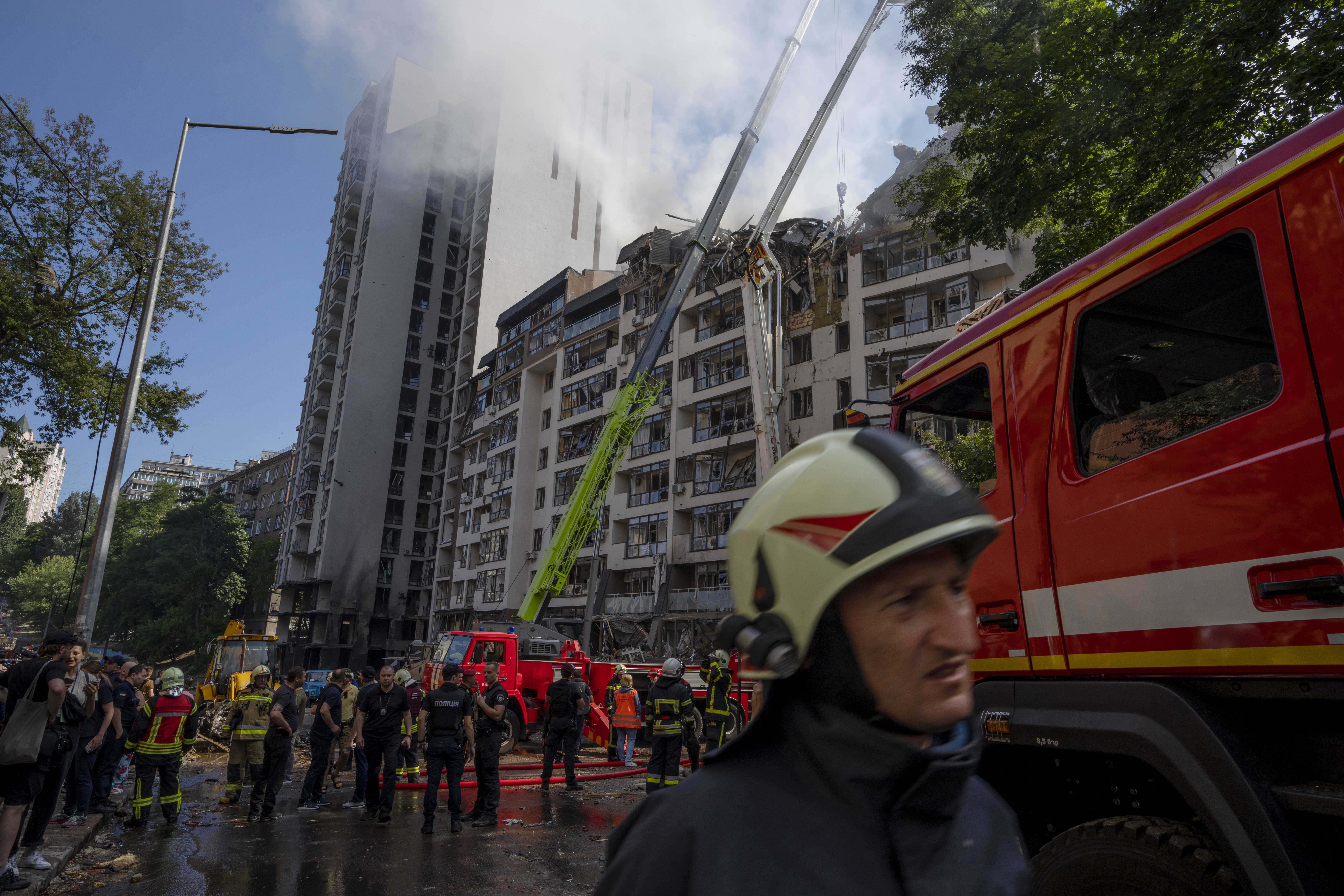 Firefighters work at the scene of a residential building following explosions, in Kyiv, Ukraine.