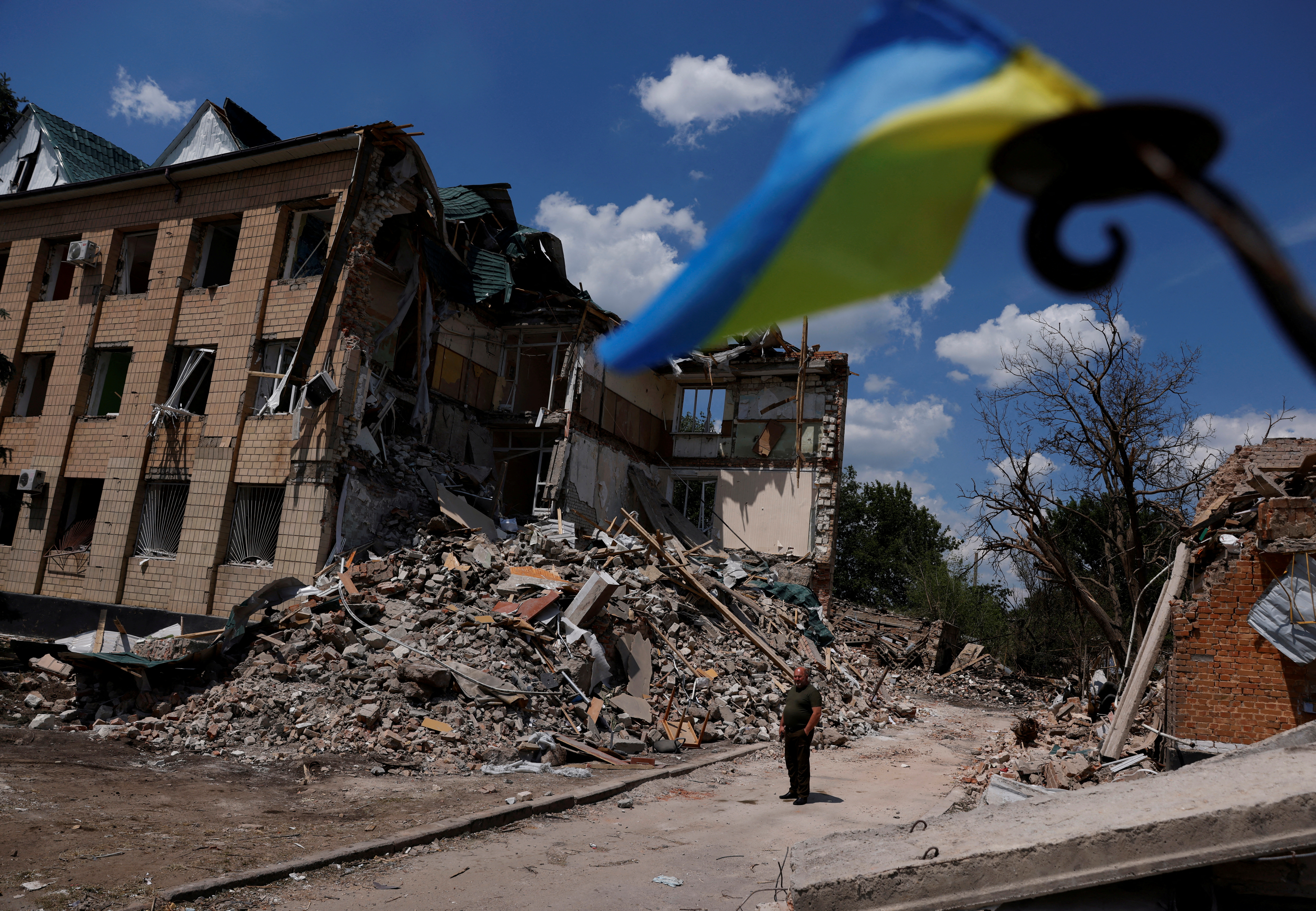 Press officer Olexii Mischenko shows a destroyed city administration building in Bashtanka, Mykolaiv region