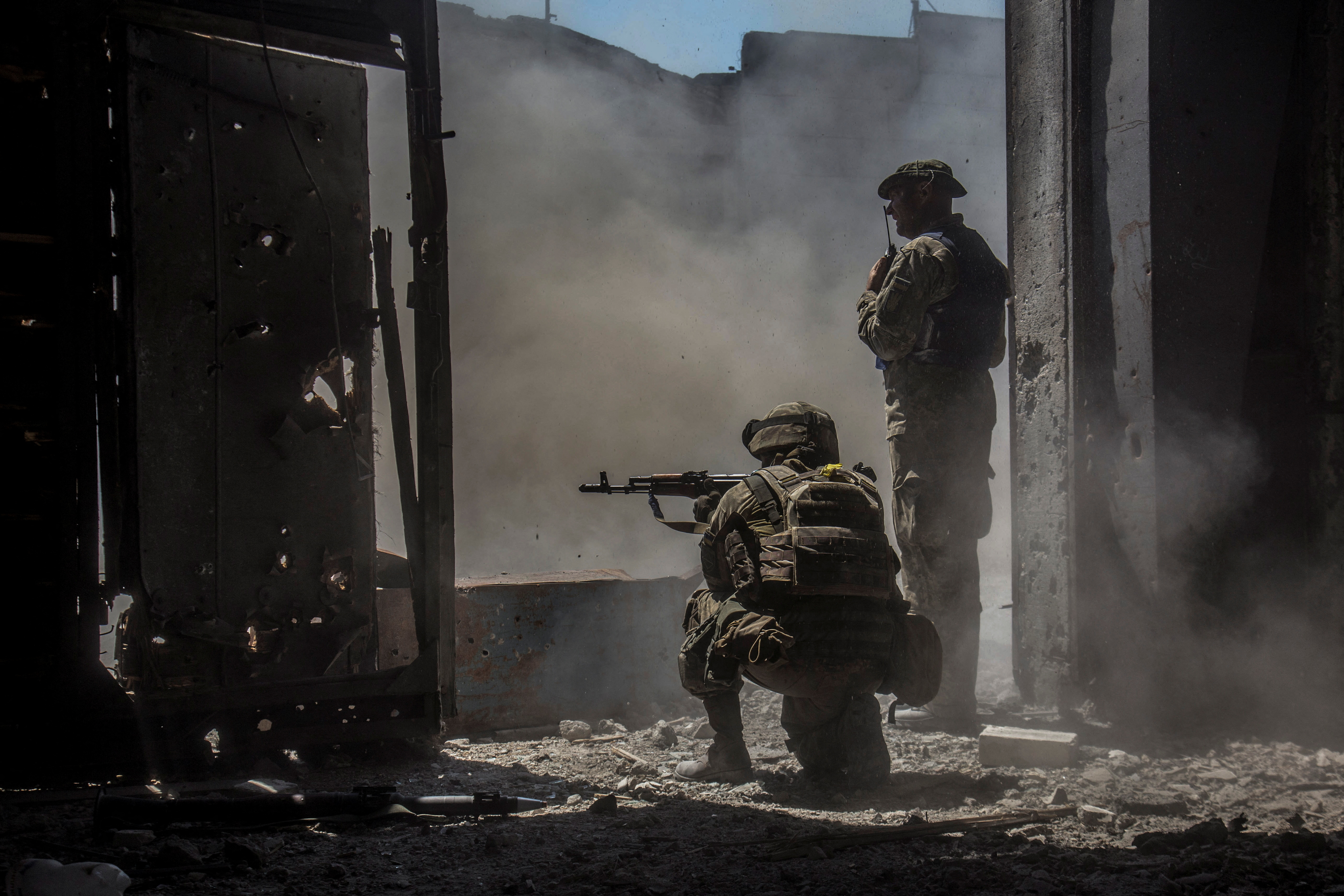 Ukrainian service members inside a damaged building in the industrial area of the city of Severodonetsk, Ukraine June 20, 2022