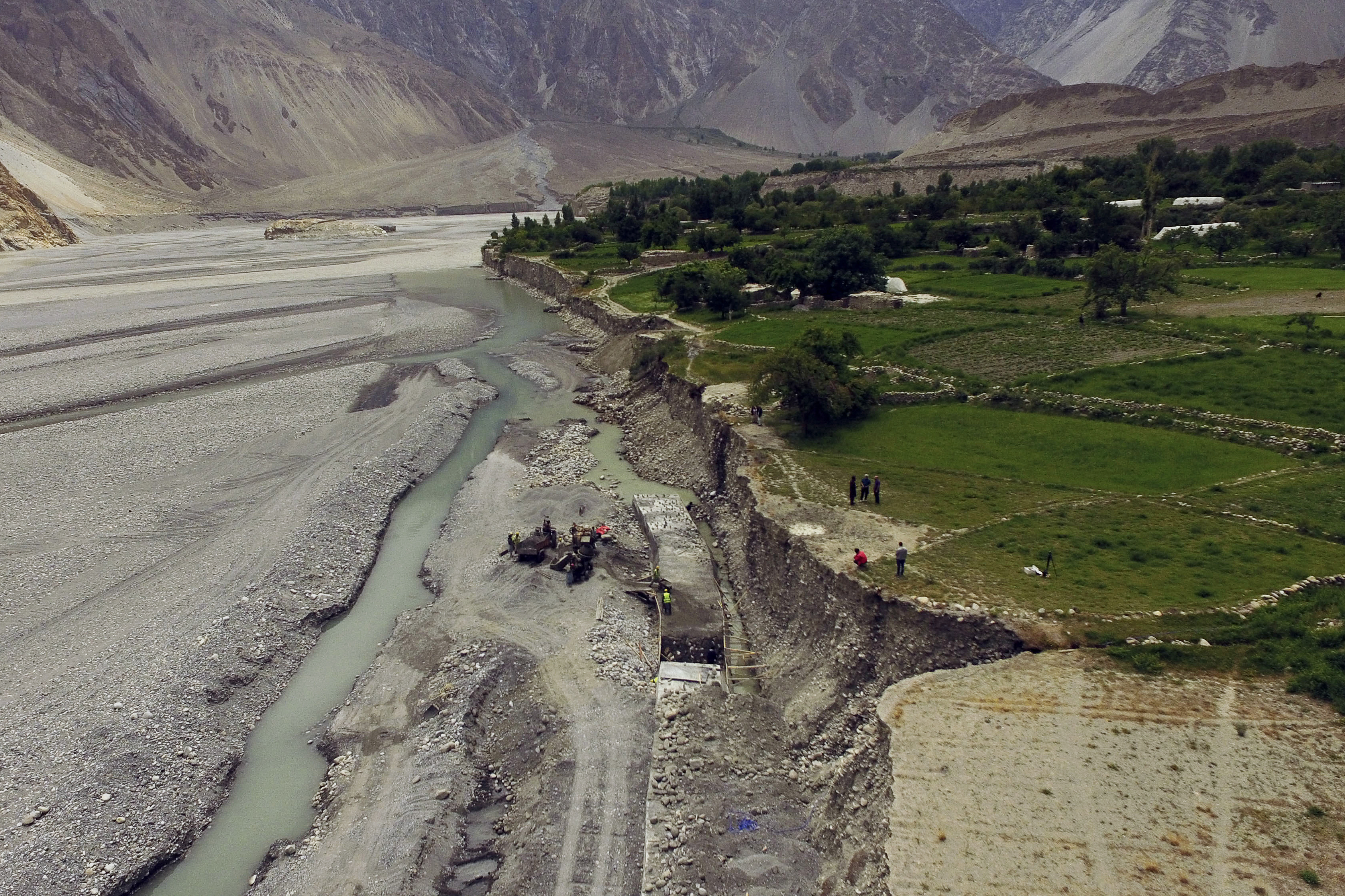 In this aerial picture taken on June 10, 2022, engineers and construction workers built a concrete wall to protect Passu village from land erosion