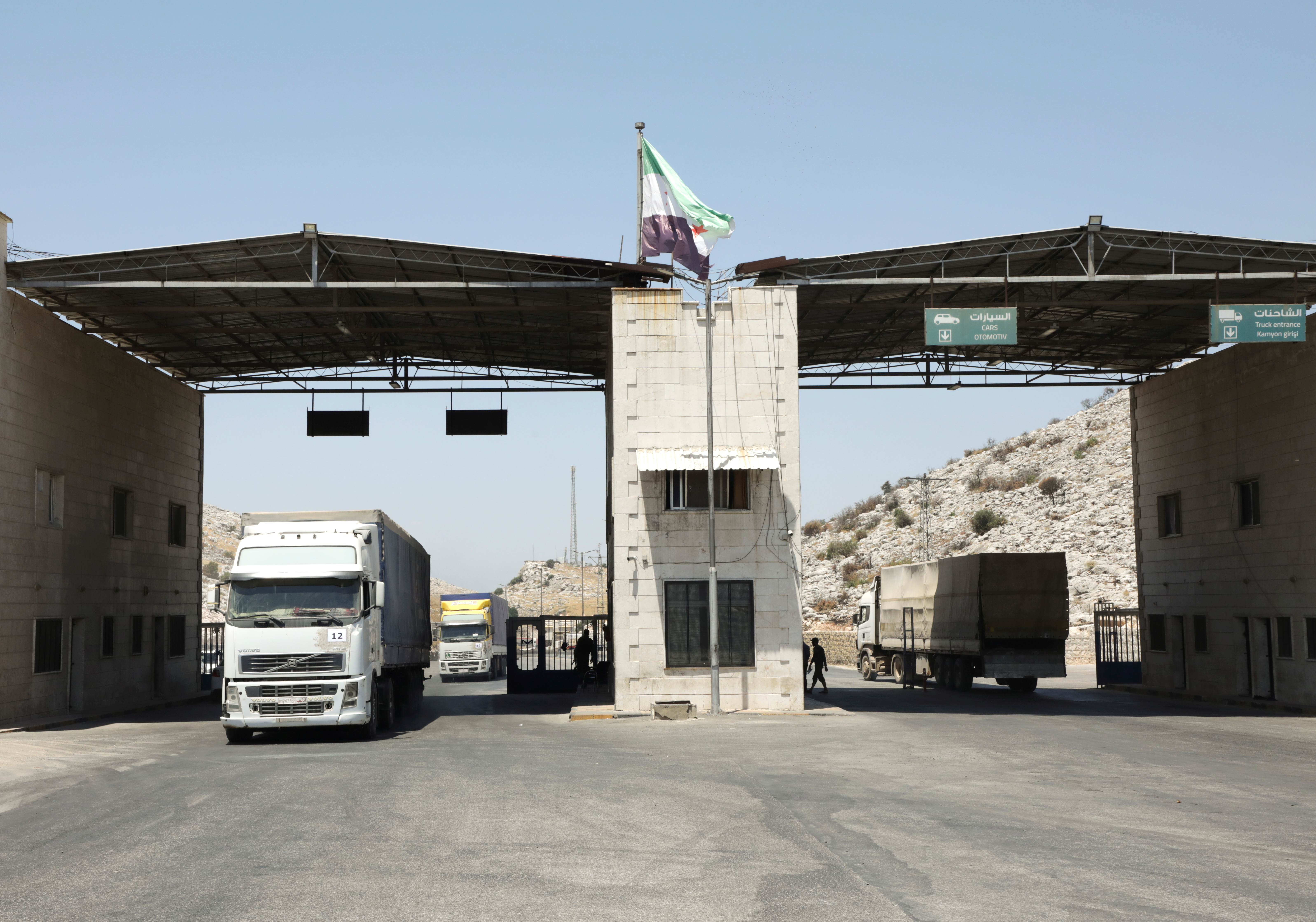 Trucks drive at Bab al-Hawa crossing at the Syrian-Turkish border, in Idlib governorate, Syria, June 30, 2021. Picture taken June 30, 2021.
