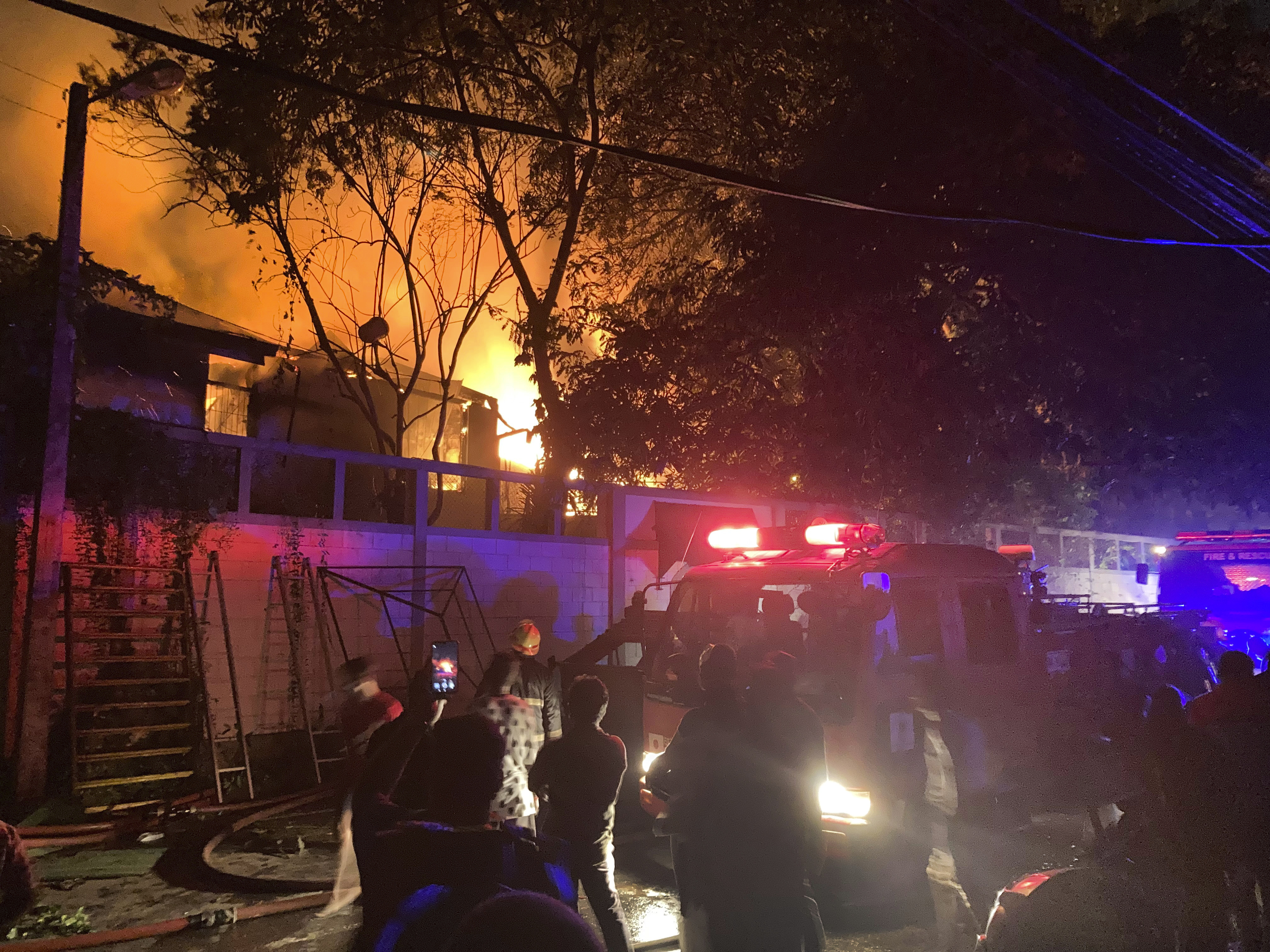 Firefighters try to douse a fire at the Sri Lankan prime minister Ranil Wickremesinghe's private residence