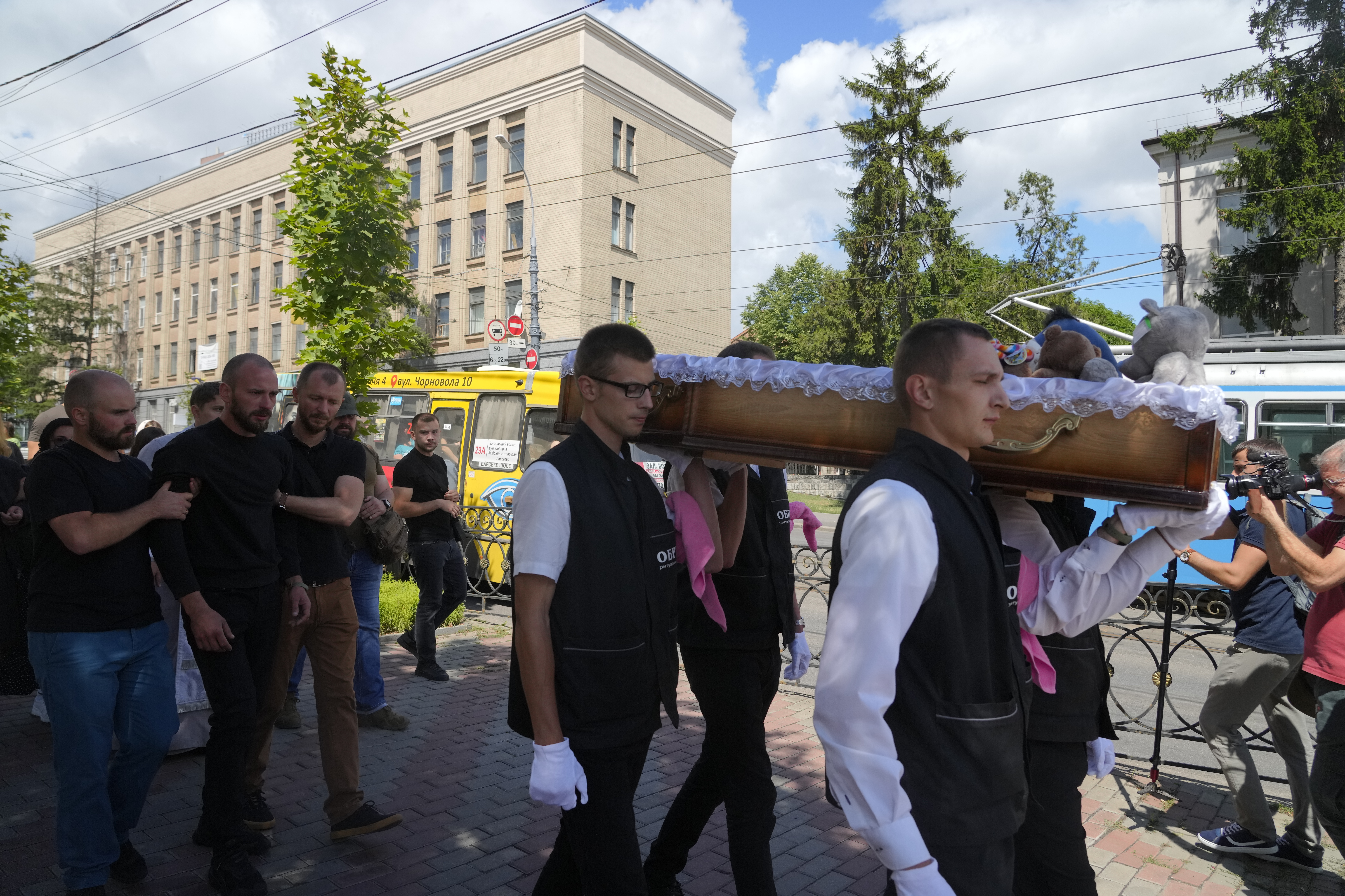 Men carry a coffin during a funeral ceremony for Liza, 4-year-old girl killed by Russian attack, in Vinnytsia, Ukraine