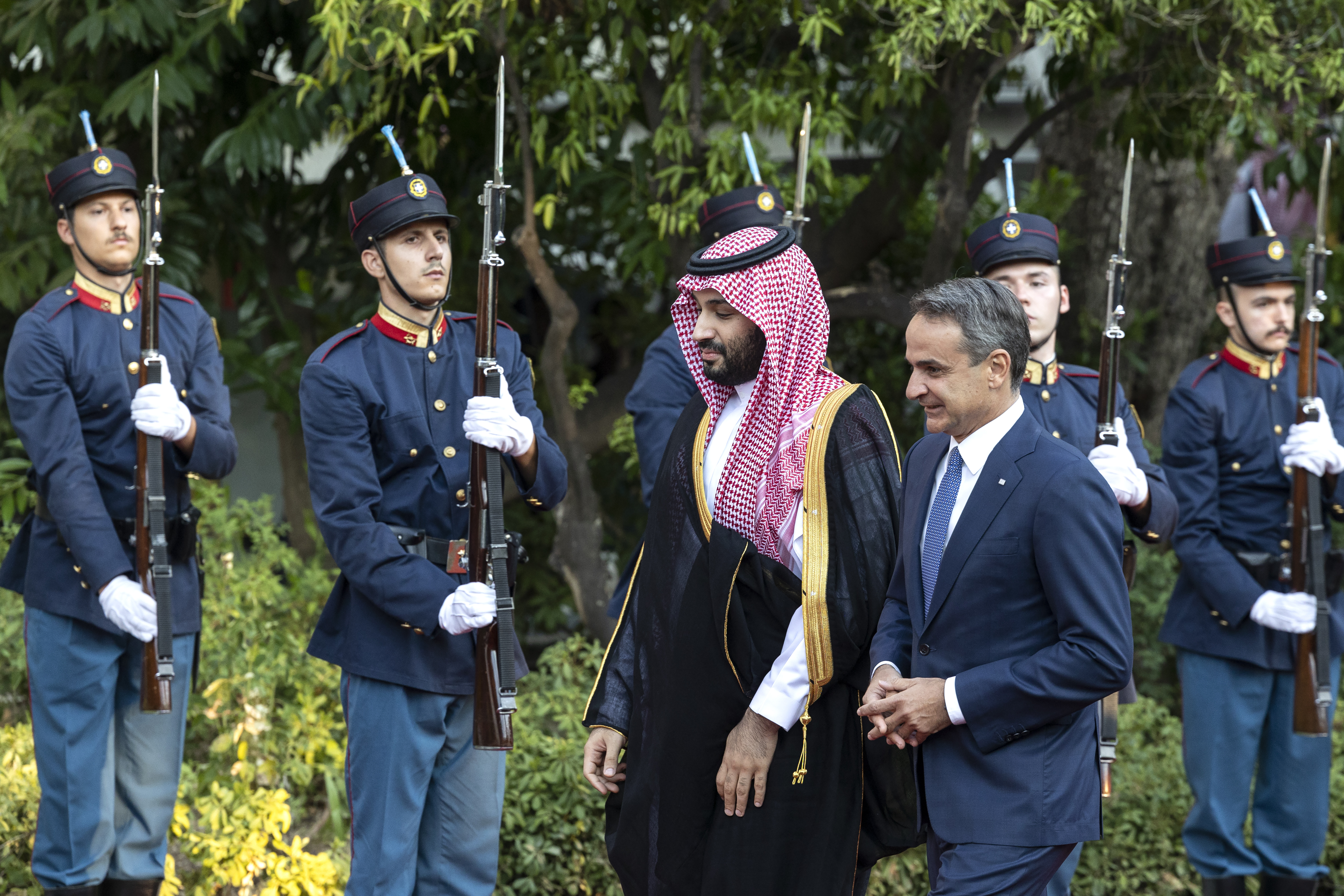 Greece's Prime Minister Kyriakos Mitsotakis, right, escorts Saudi Crown Prince Mohammed bin Salman as they inspect a guard of honour, in Athens