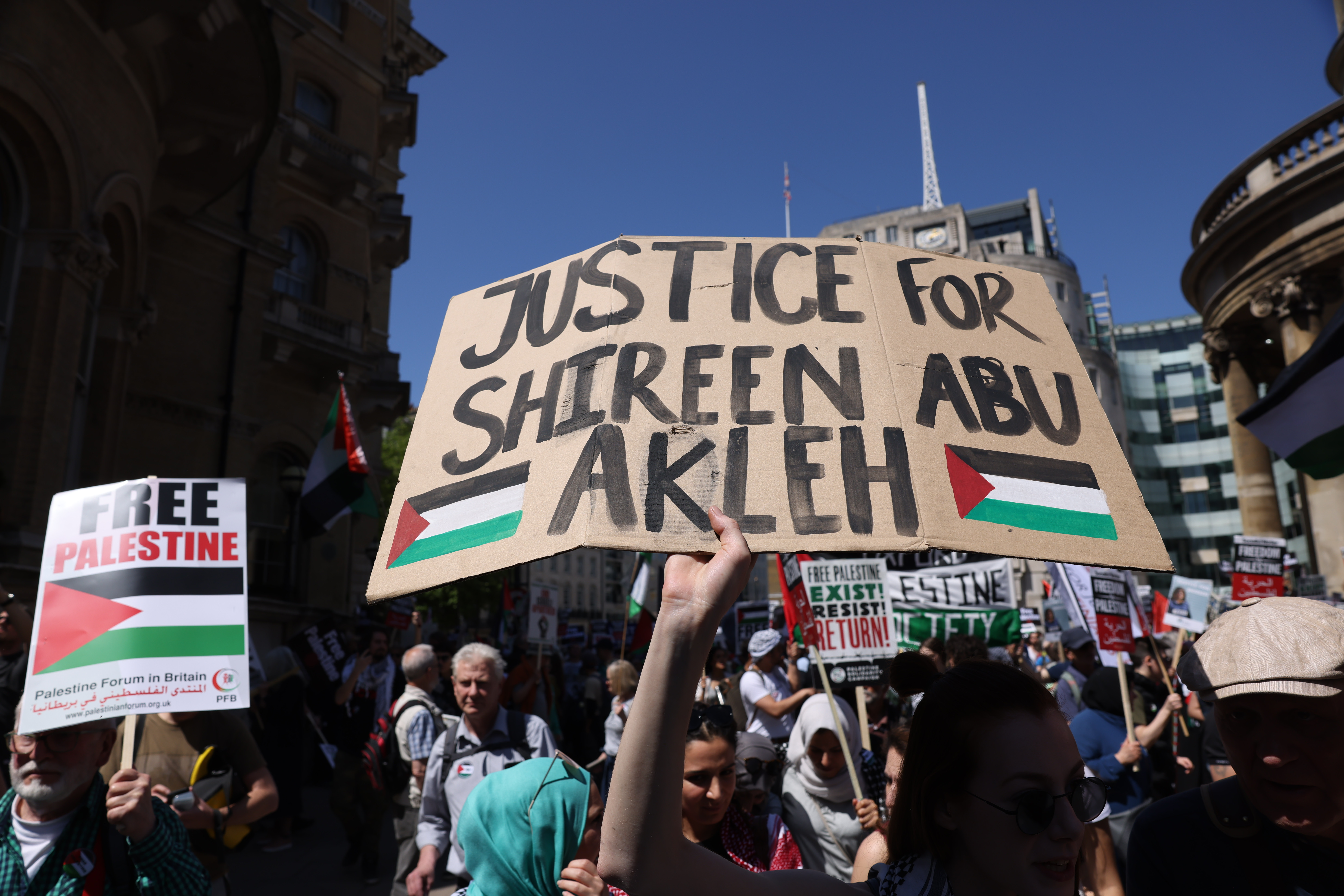 Demonstrators hold placards during the Free Palestine, End Apartheid protest outside BBC Broadcasting House May 14, 2022 in London, England.
