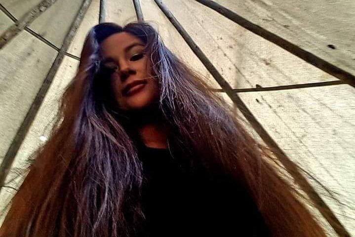 A photo of Chantalle Buffalo standing inside a teepee.