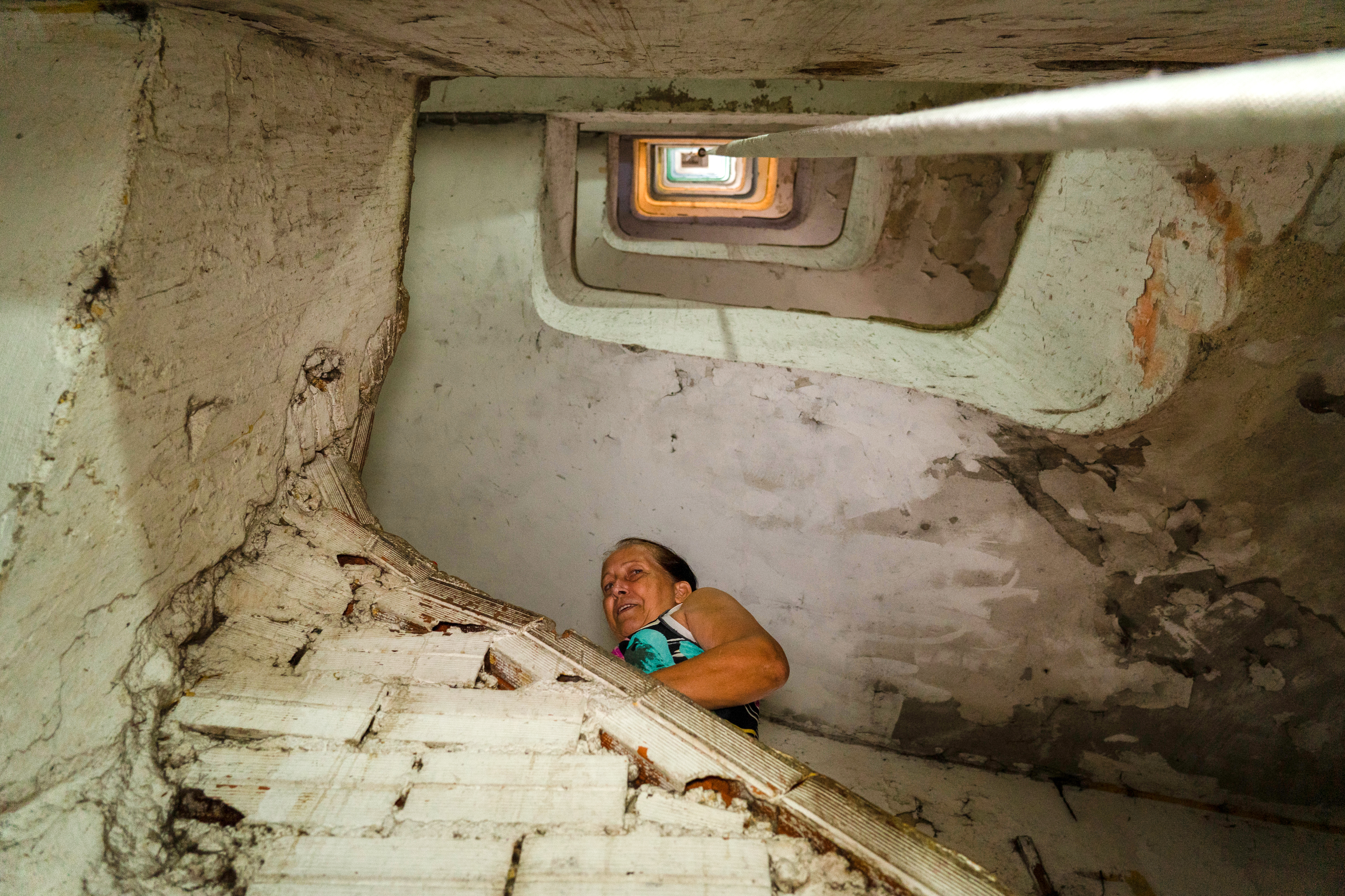 A resident is seen climbing the stairs of the 21-story high building.