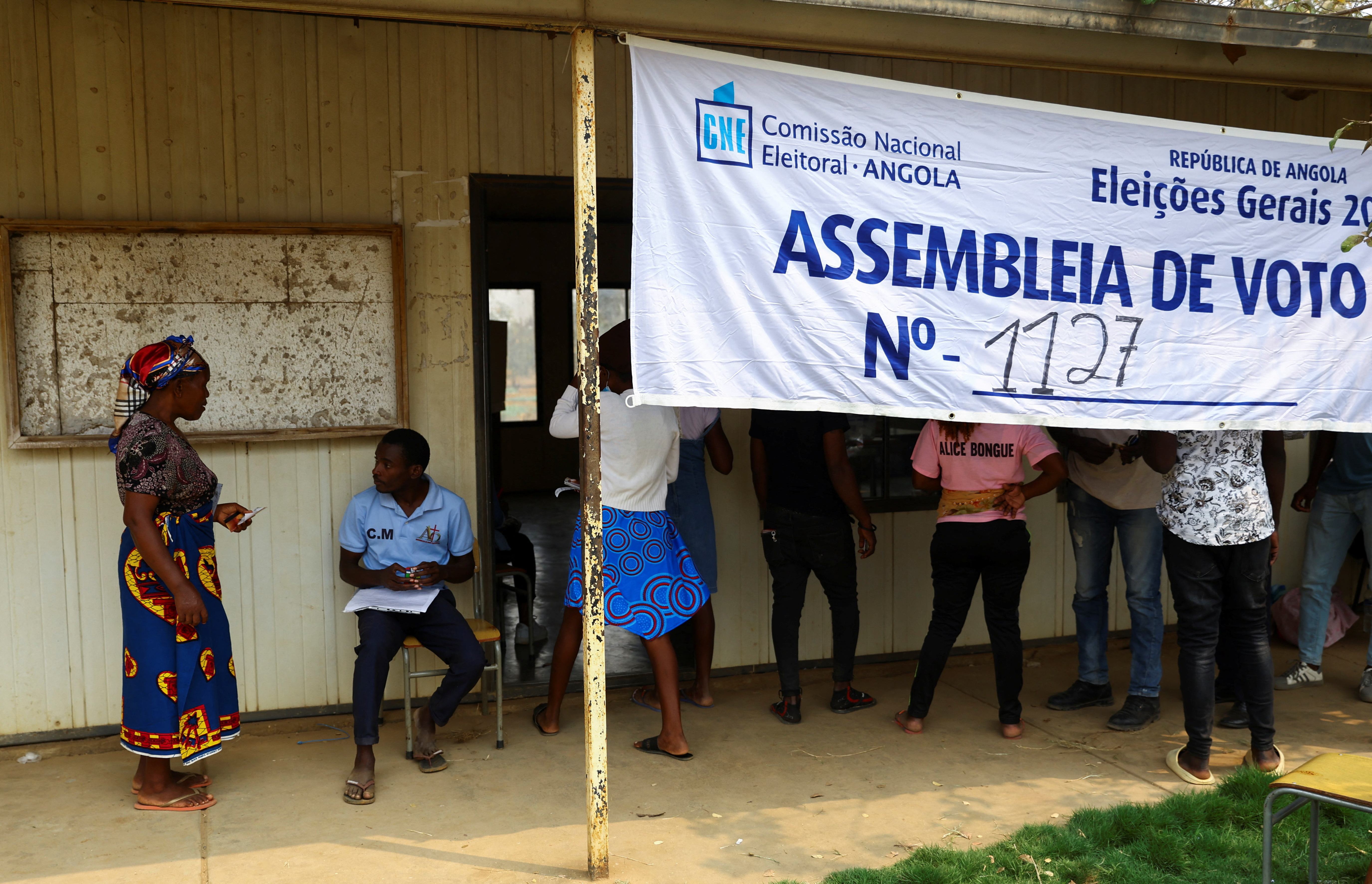 A woman arrives at a voting station before casting her vote during the general election in Cacuaco