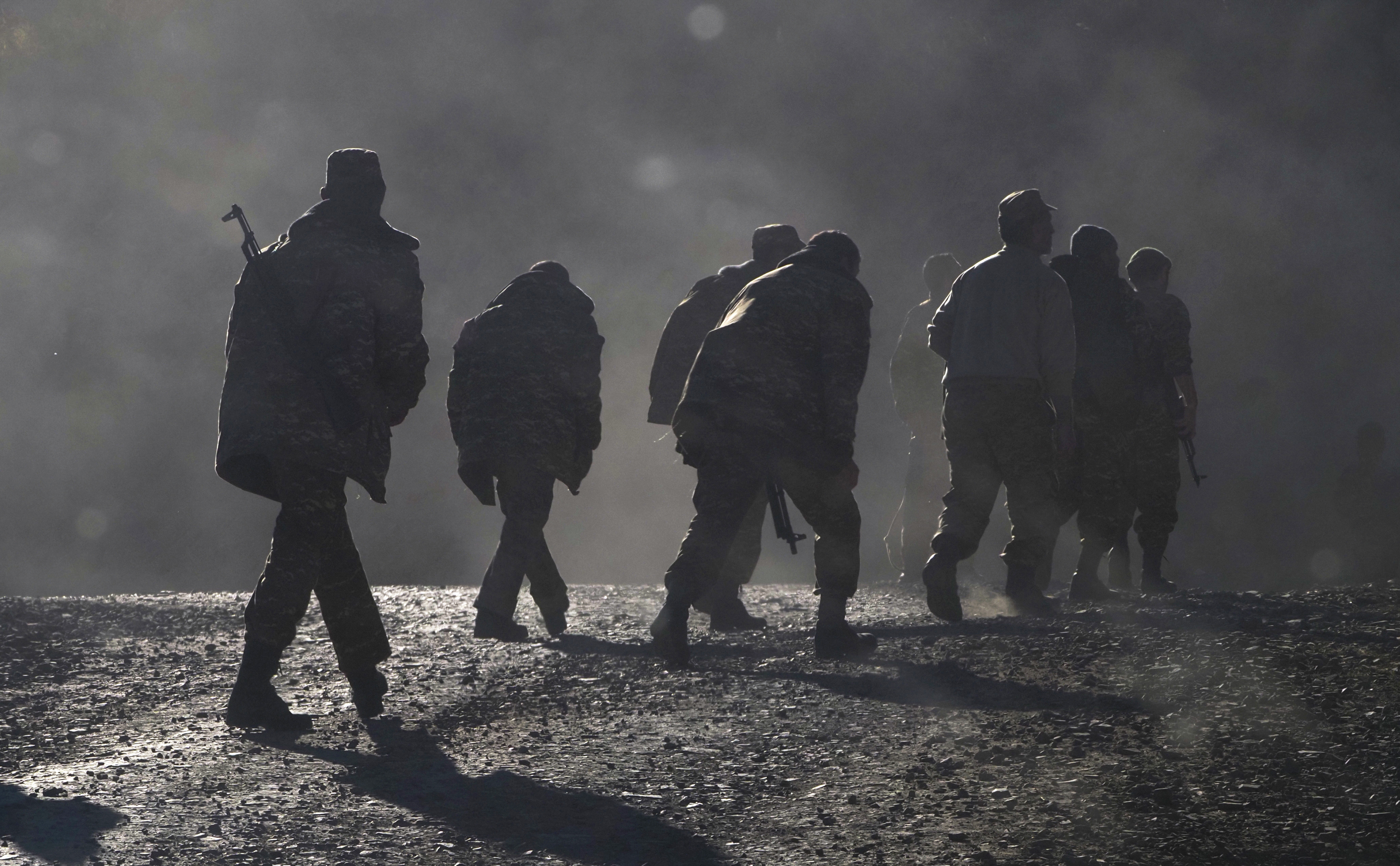 Ethnic Armenian soldiers walk along a road