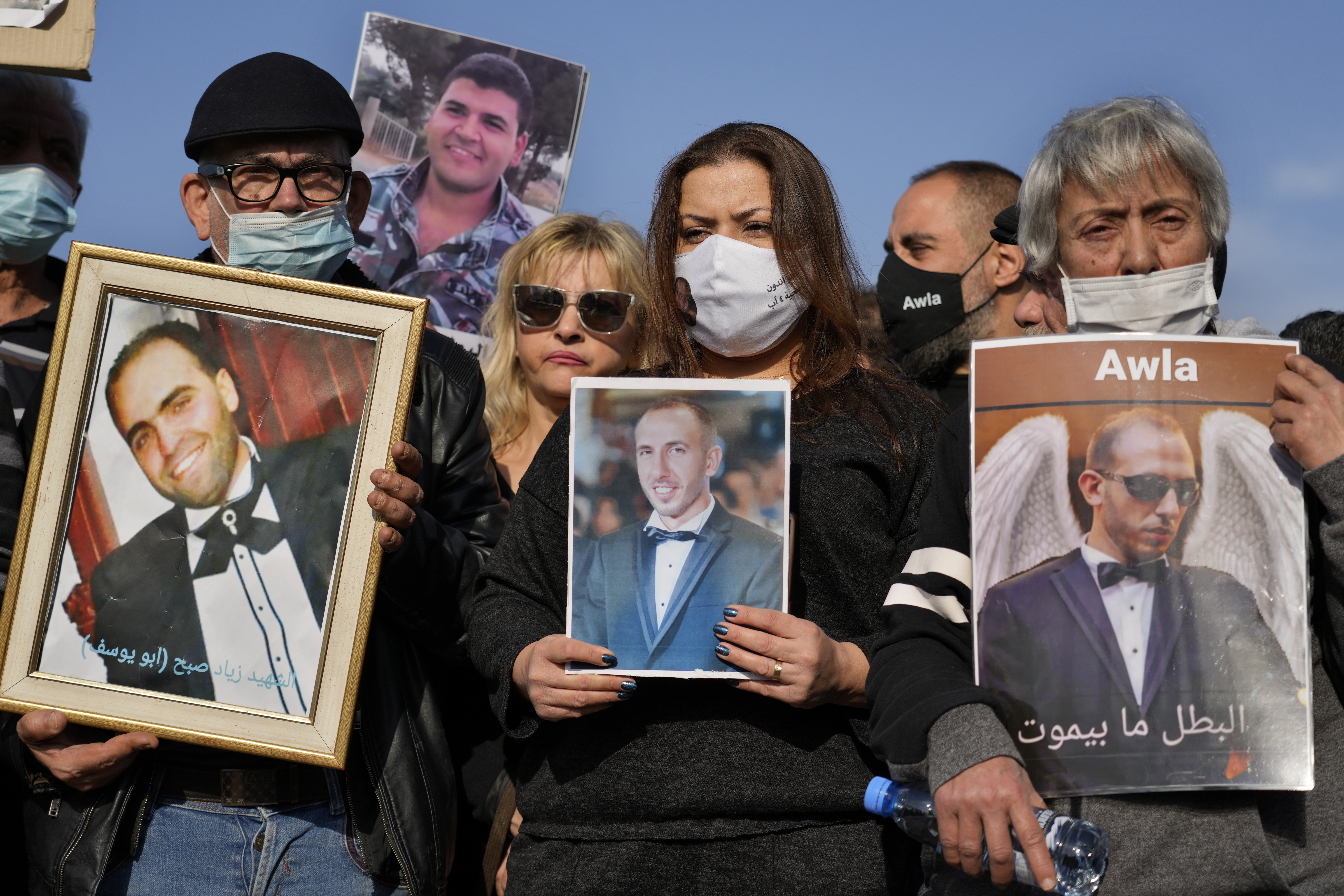 Relatives of victims of the deadly 2020 Beirut port explosion hold portraits of their loved ones and called for no reconstruction before the truth is revealed about the blast, during a protest near the port, in Beirut, Lebanon