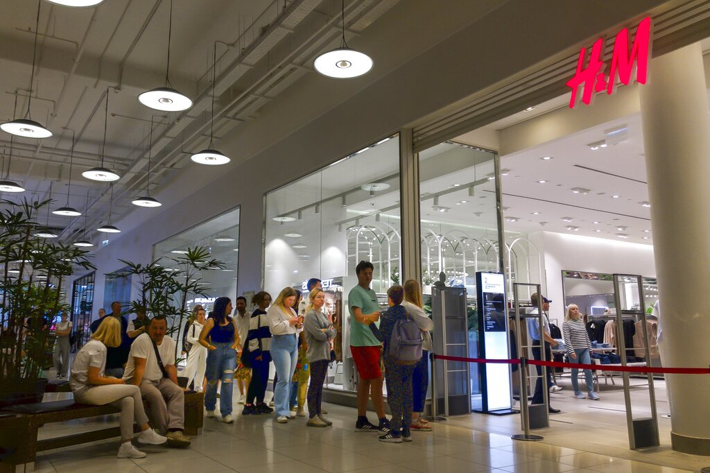 People line up to enter an H&M shop and buy items on sale in the Aviapark shopping mall in Moscow, Russia