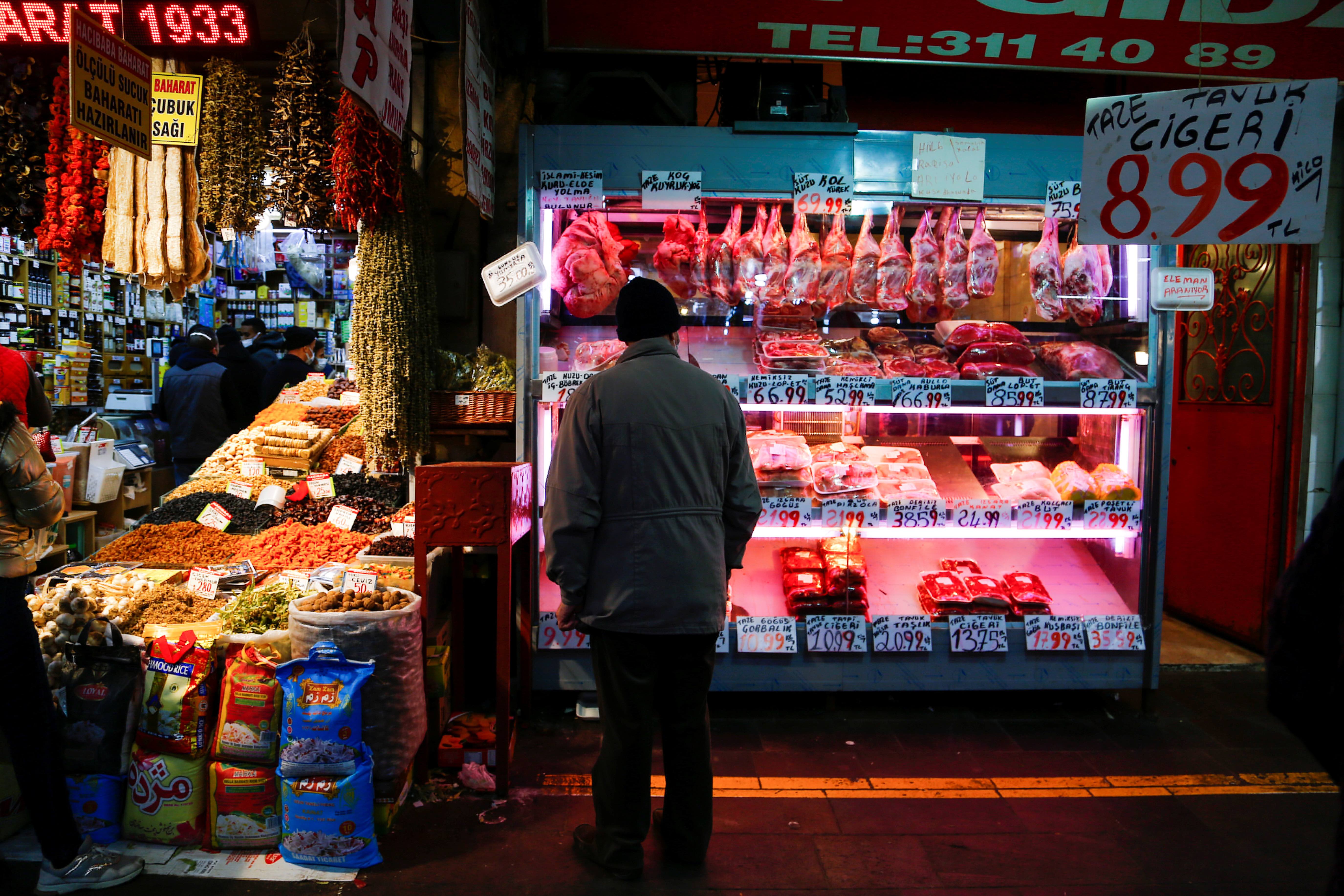 A man looks at a butcher shop window in Ankara, Turkey